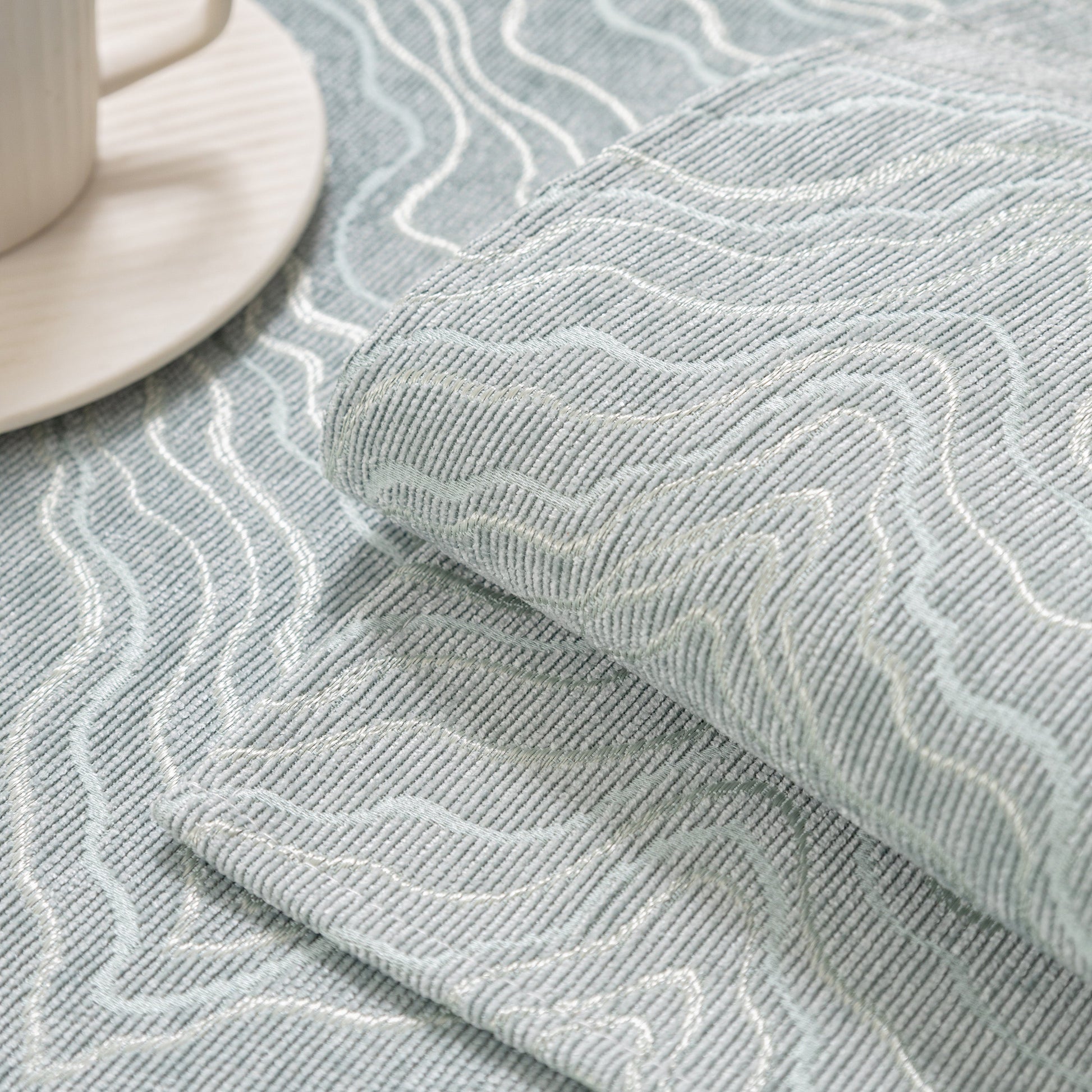 Close-up of modular sofa cover fabric showing wave pattern texture, featuring gold striped non-slip design for sectionals and couches.