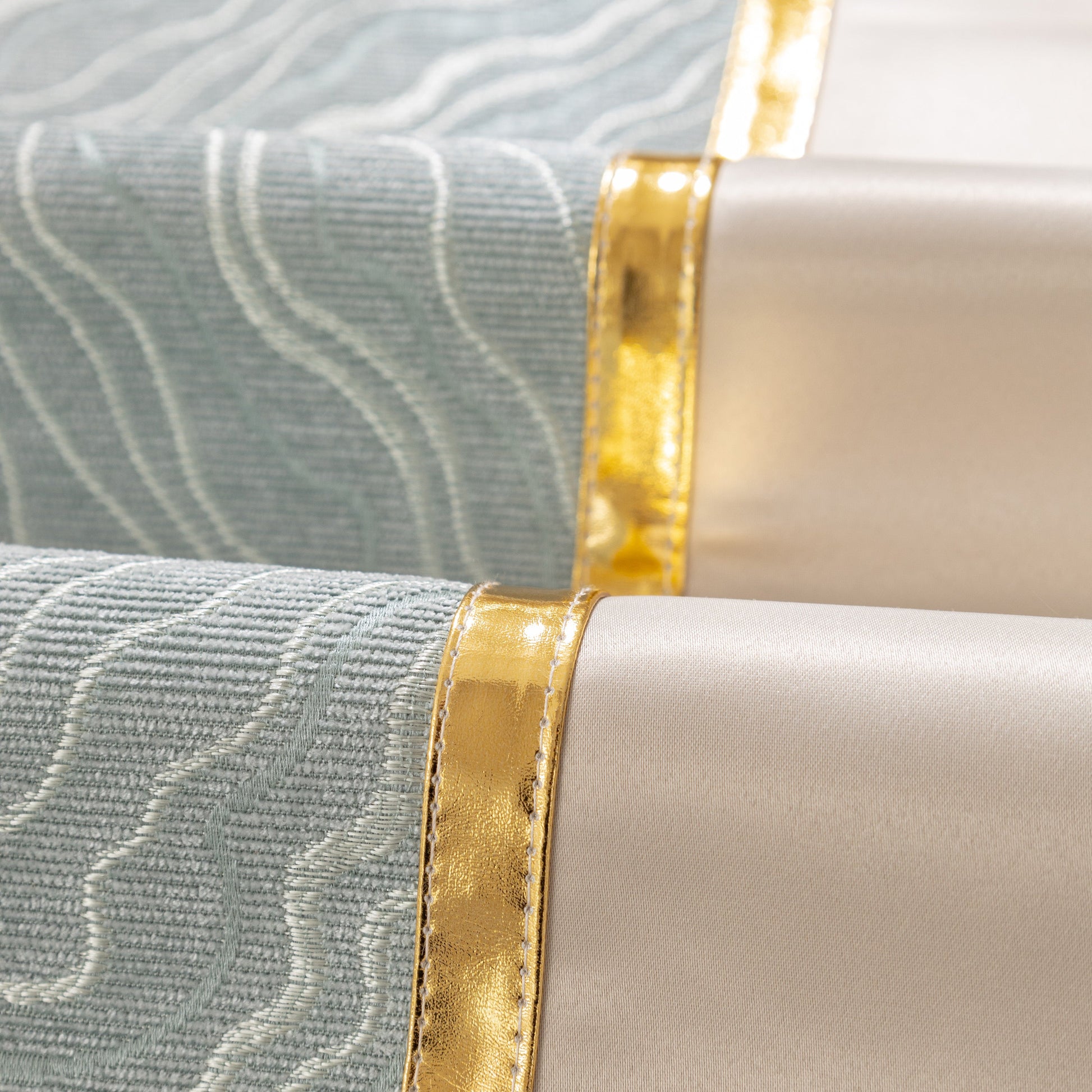 Close-up of Modular Sofa Cover for Sectionals, Gold Striped Non-Slip Couch Protector with wave texture and gold accents.