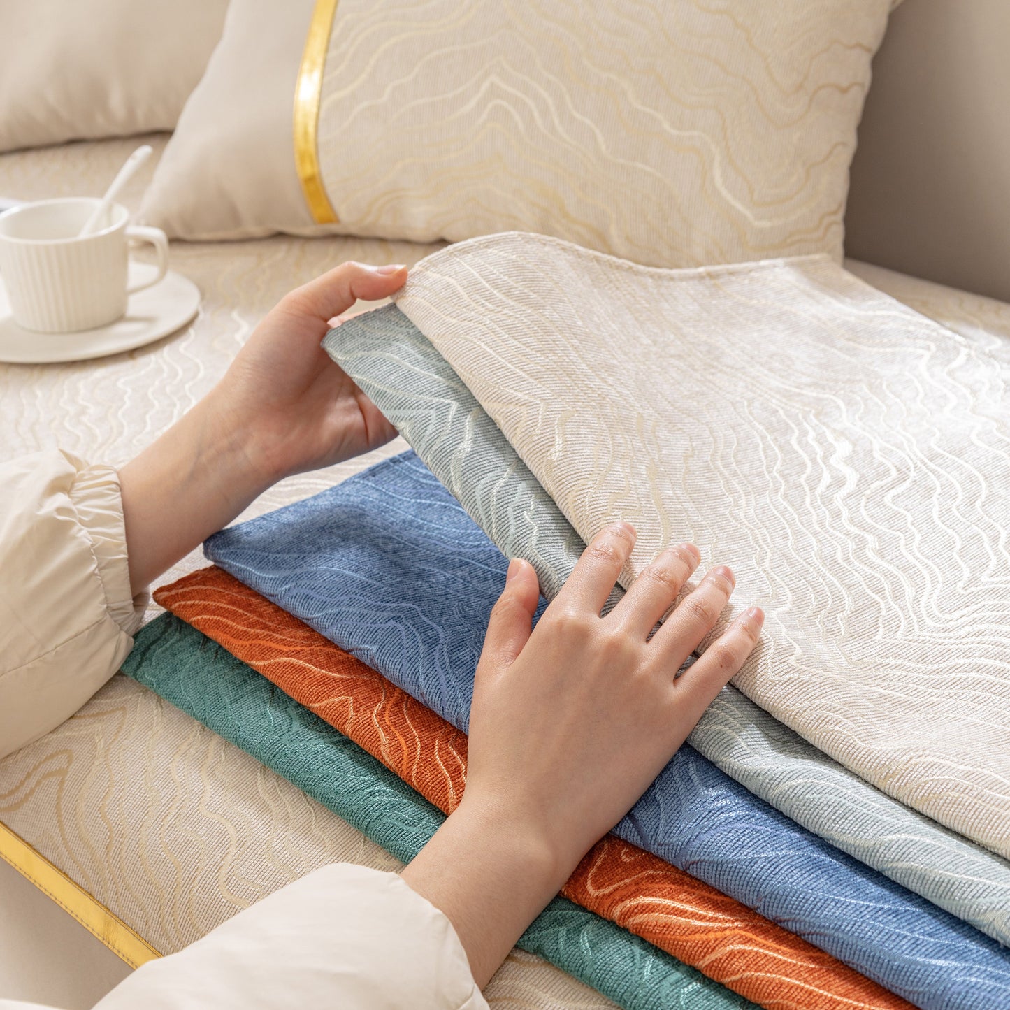 Stack of colorful modular sofa covers with gold stripes, featuring the Modular Sofa Cover for Sectionals, Gold Striped Non-Slip Couch Protector.
