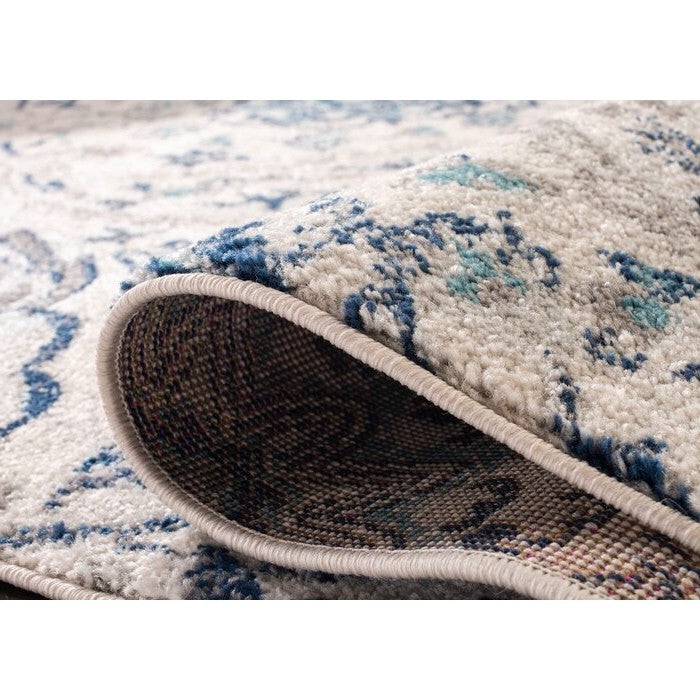 Close-up of 5' x 7' Coastal Blue Grey Damask Indoor Area Rug showing texture and pattern detail with cream, light gray, and navy hues.