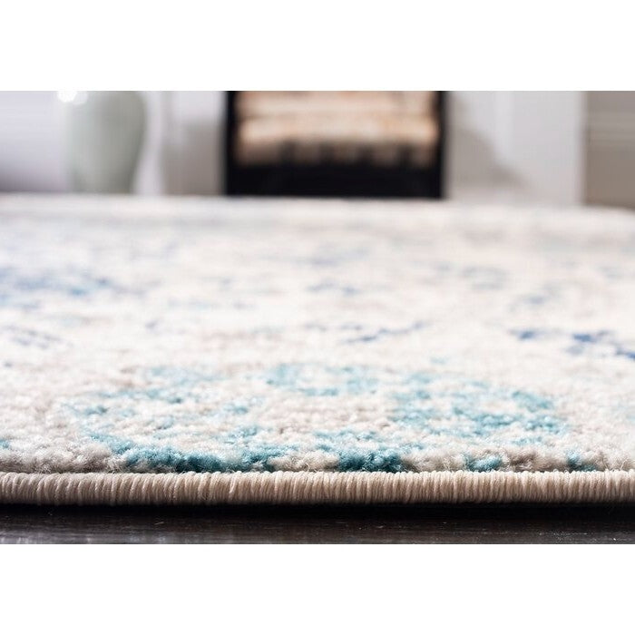 Close-up of 5' x 7' Coastal Blue Grey Damask Indoor Area Rug with cream and navy pattern, showing the texture and pile height.