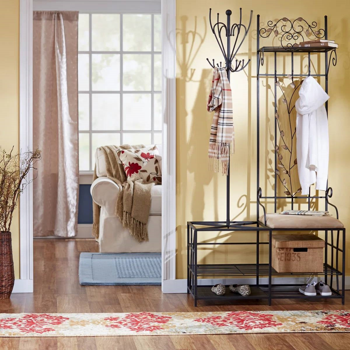 Entryway Hall Tree Coat Rack Storage Bench with Scrolling Leaves Scrollwork in a cozy living room setting.