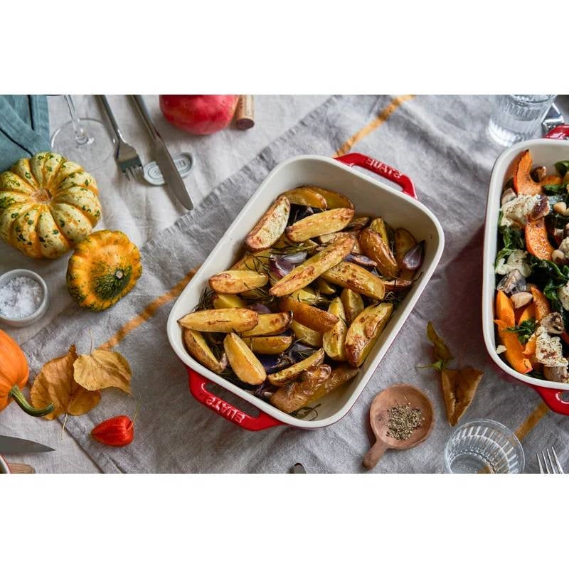 2 Piece Ceramic Stoneware Baking Dish Set in Cherry Red / Ivory filled with roasted vegetables on a table setting