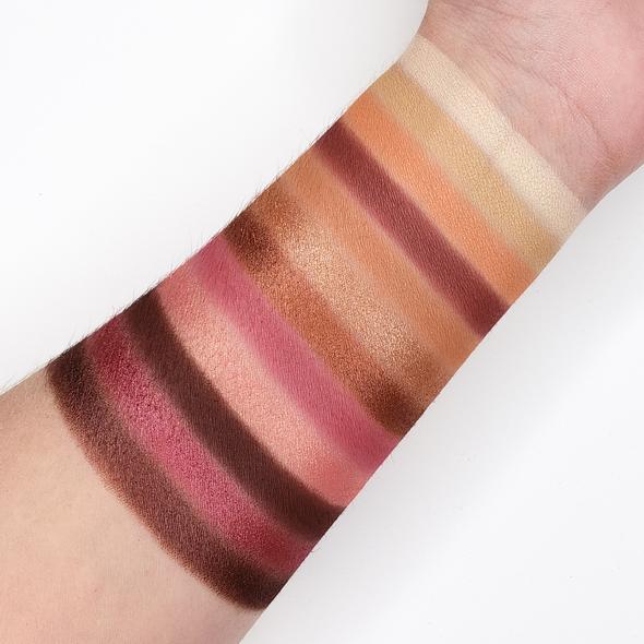 Swatches of CITY NIGHTS PALETTE 26CN eyeshadow shades on arm, showcasing warm rose tones and neutrals with shimmer and matte finishes.