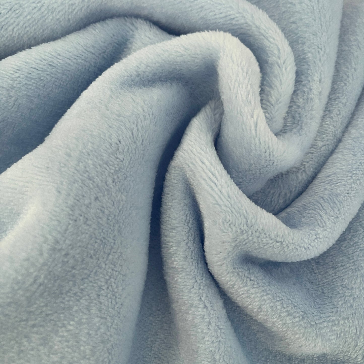Close-up of ultra soft flannel fabric of the Golf / Travel Blanket, showcasing plush texture and comfort, perfect for travel or gifting.