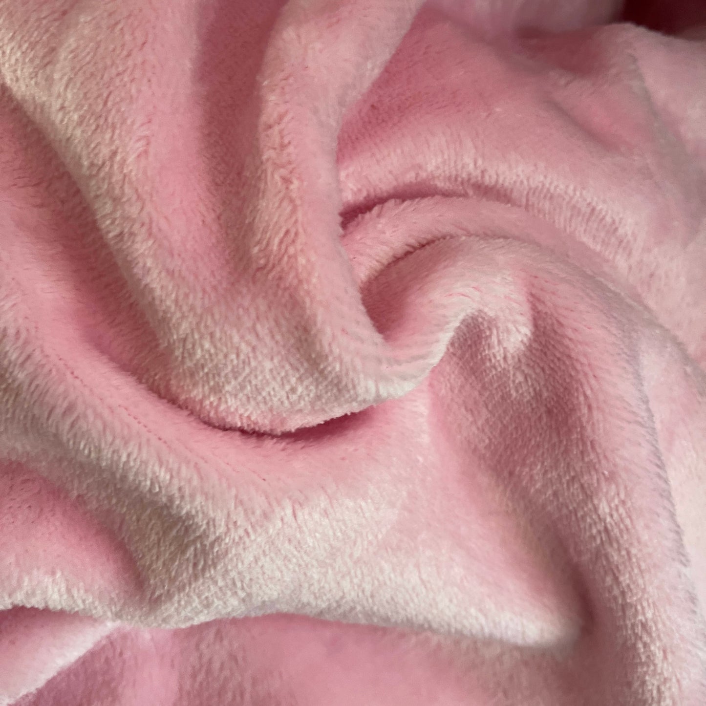 Ultra soft pink flannel Golf / Travel Blanket for cozy warmth, shown in close-up, highlighting plush texture for golf or travel comfort.