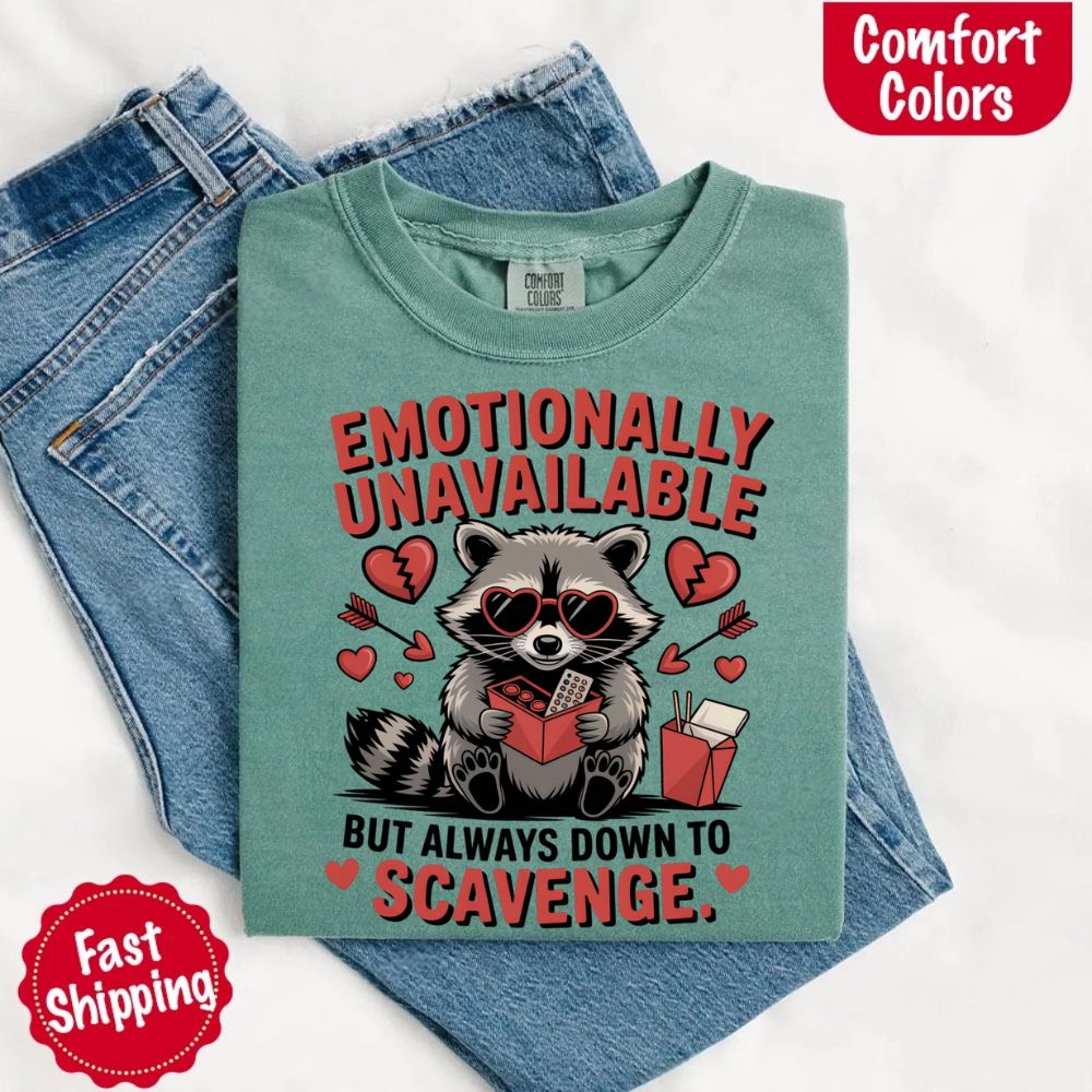 Comfort Colors Emotionally Unavailable Raccoon T-Shirts featuring moody raccoon graphic, styled with jeans, fast shipping option.