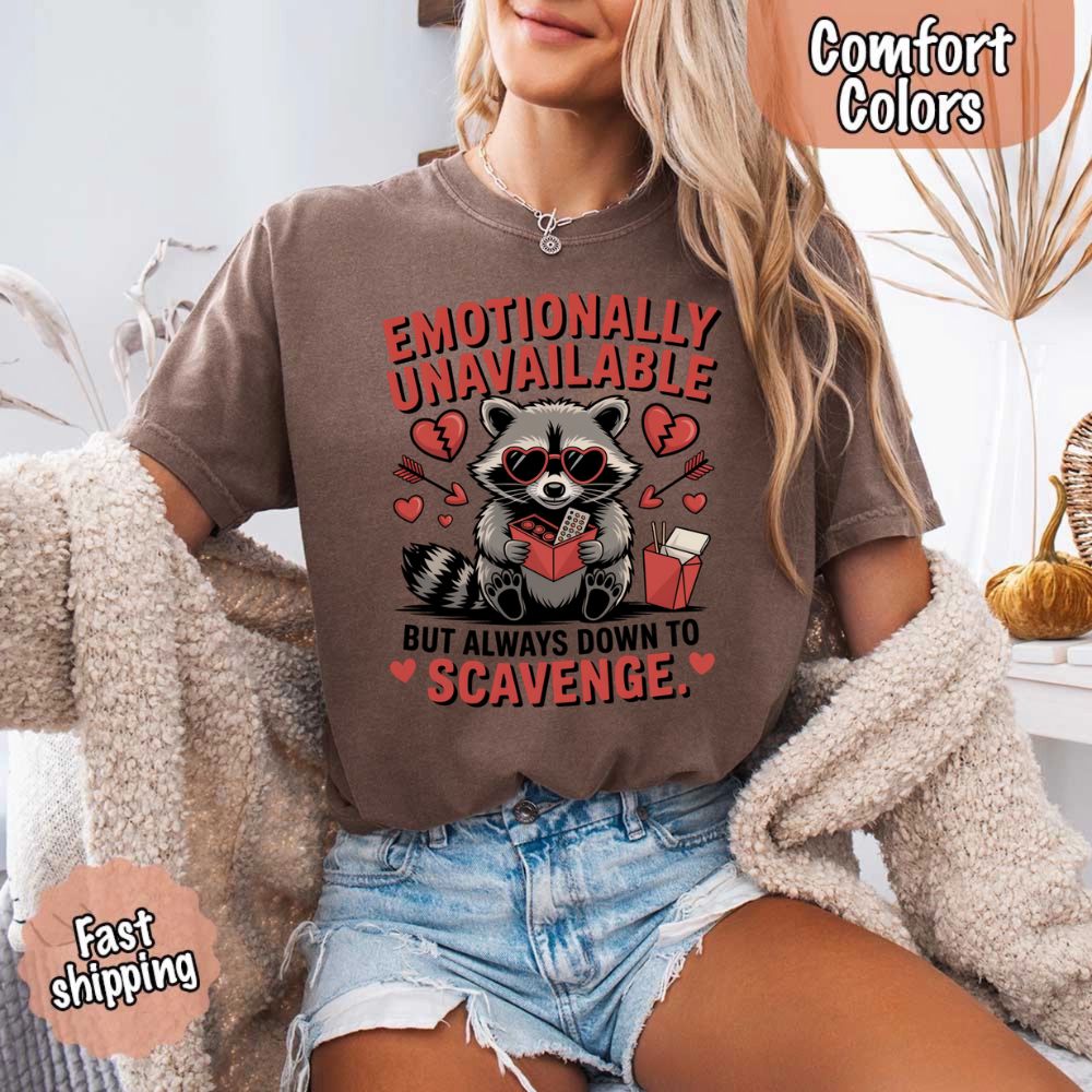 Woman wearing Comfort Colors Emotionally Unavailable Raccoon T-Shirts with moody raccoon print, emphasizing humor and comfort.
