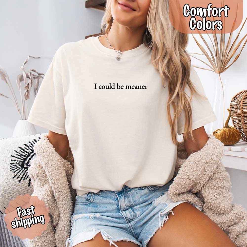 Woman wearing 'I Could Be Meaner Funny Sarcastic Tee', showcasing trendy streetwear style. Perfect for adding edge to everyday fashion.