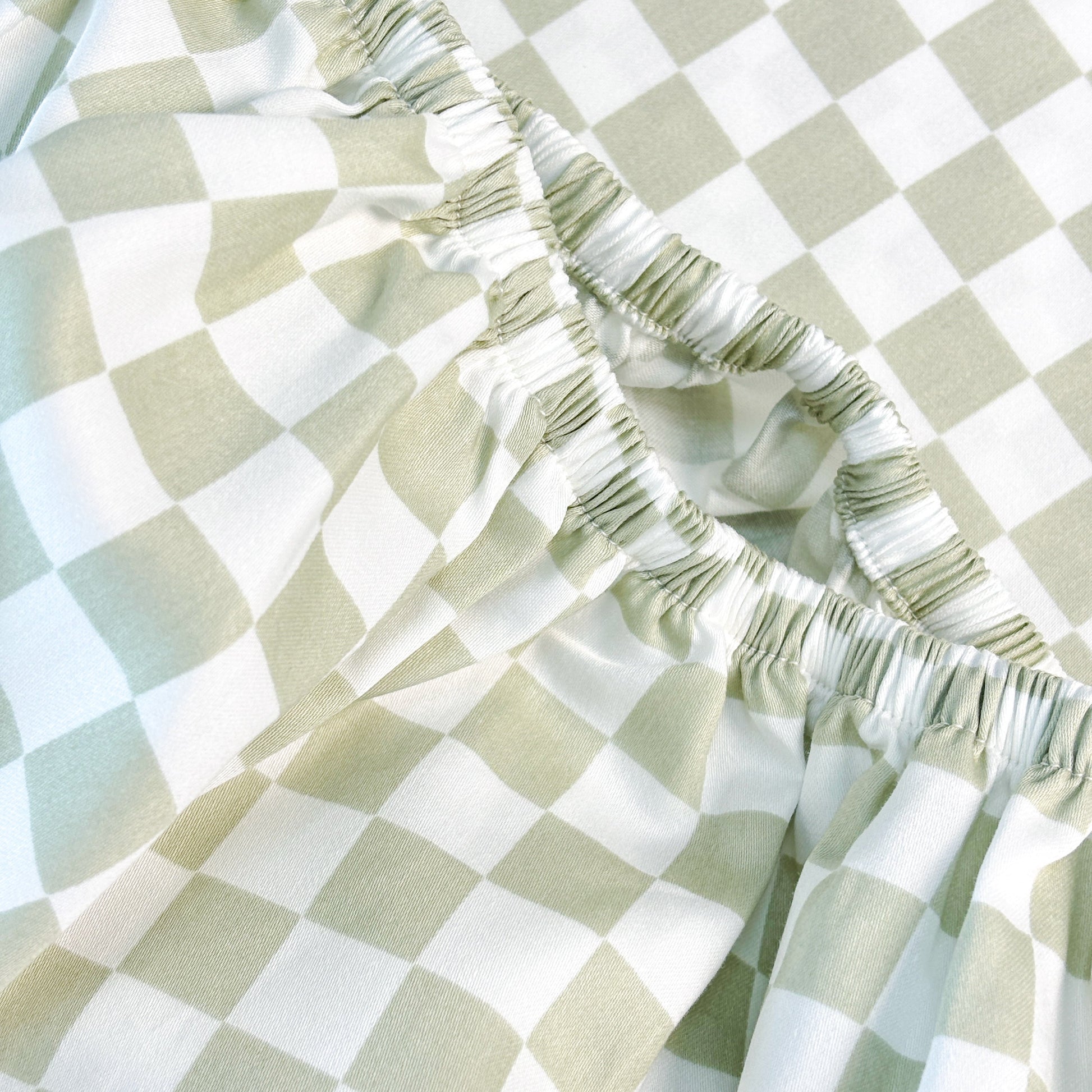 Close-up of SHNUGGLE Bedding Set Sage Checker with soft wrinkle-resistant fabric and sage checkered pattern.