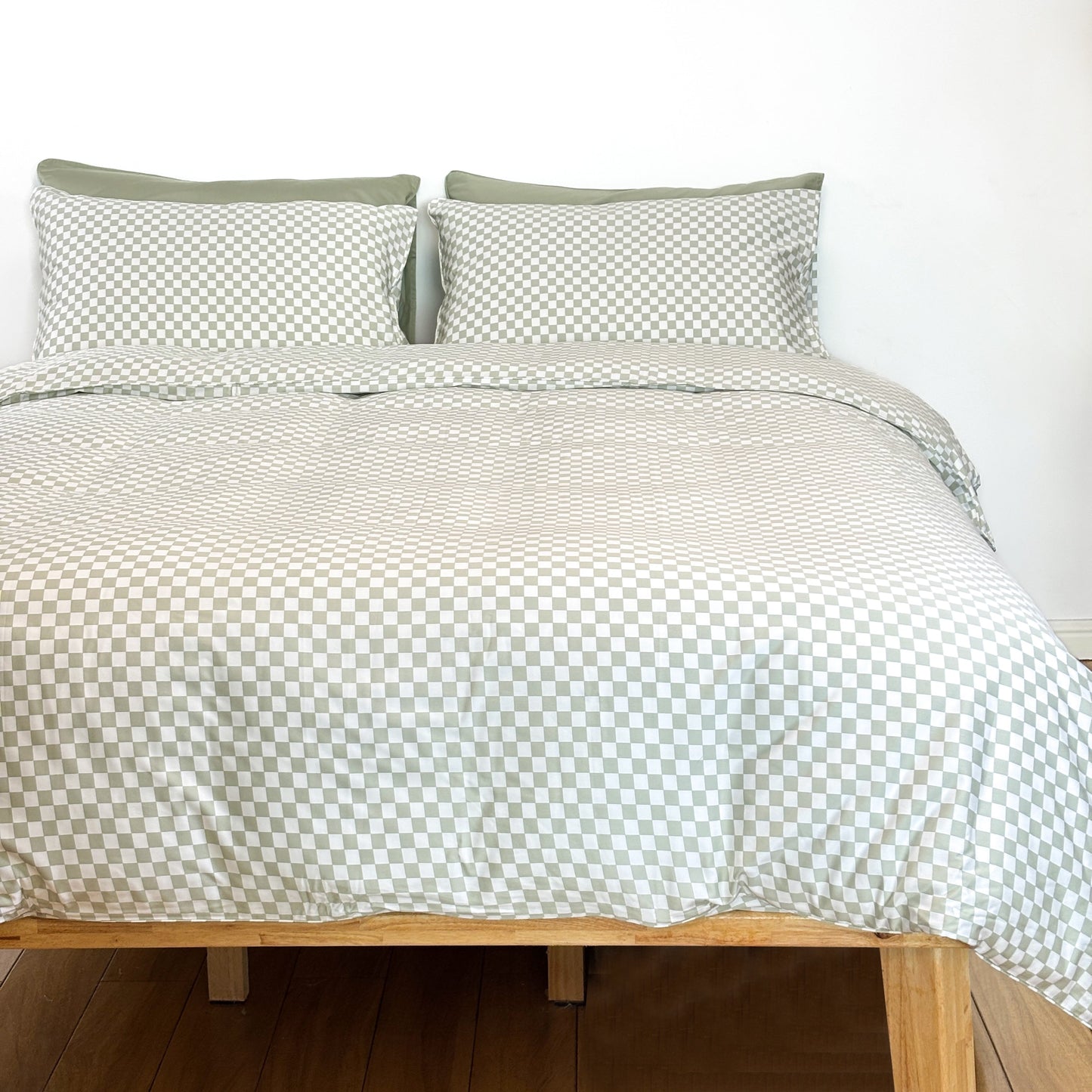 SHNUGGLE Bedding Set Sage Checker on bed showcasing checkered design