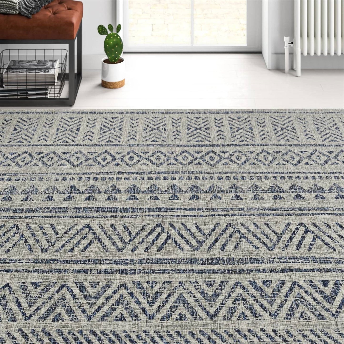 5 ft. x 7.5 ft. Blue Grey Chevron Coastal Boho Style Indoor Outdoor Area Rug with geometric patterns in a living room setting
