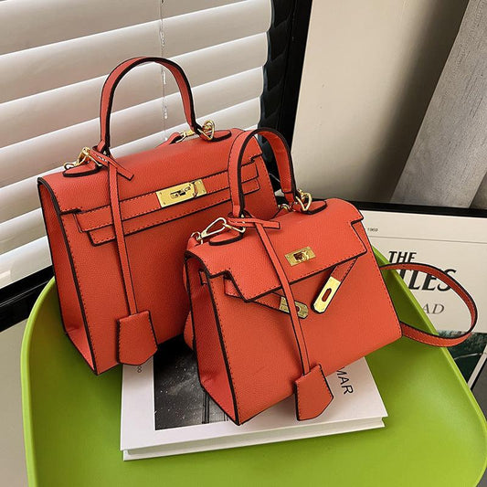 Luxury Cowgirl Kelly Purse – Trendy, High-Fashion Leather Handbag with Adjustable Strap displayed on a green table.