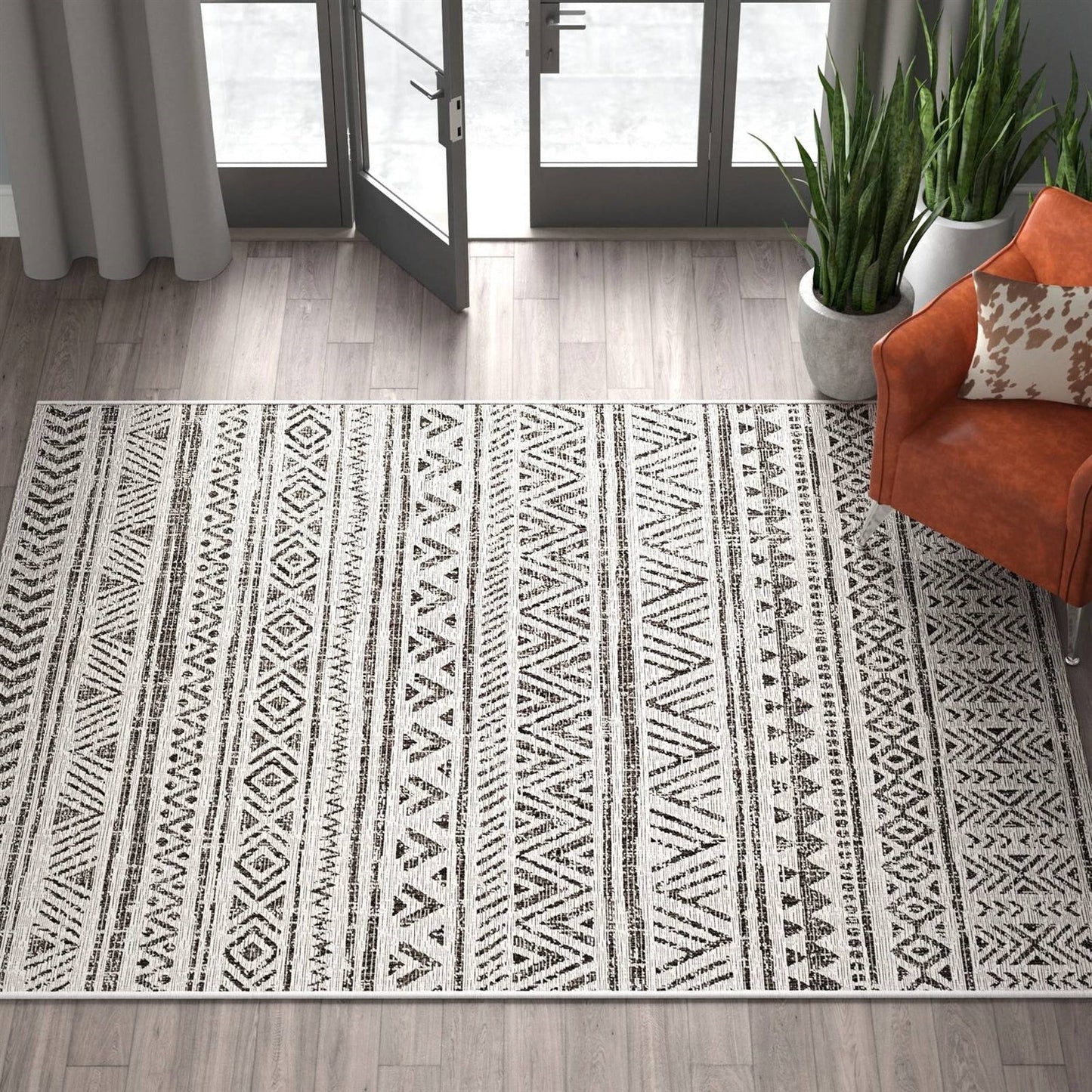 5 ft. x 8 ft. Black Off-White Chevron Coastal Boho Style Indoor Outdoor Area Rug on wood floor
