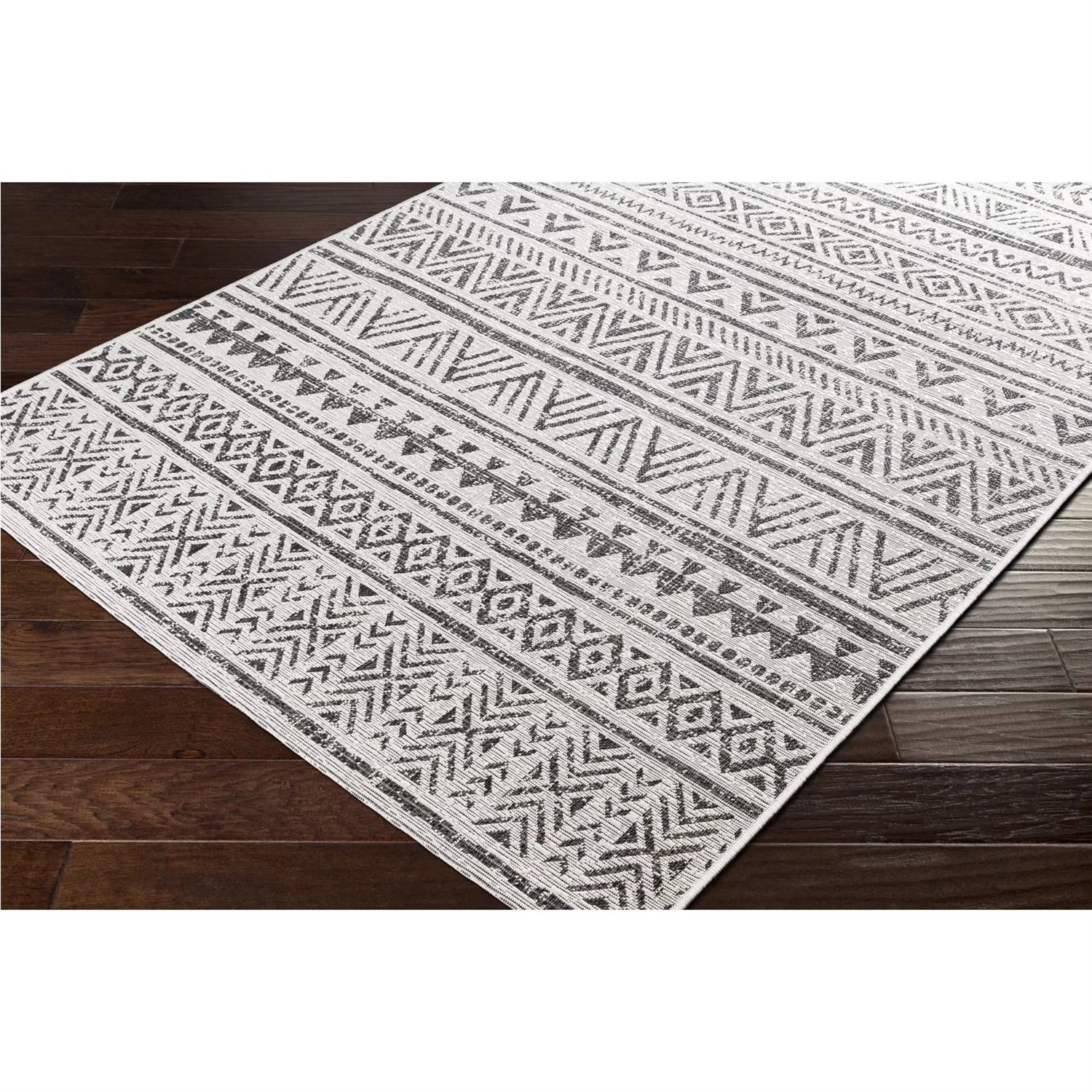 5 ft. x 8 ft. Black Off-White Chevron Coastal Boho Style Indoor Outdoor Area Rug with geometric patterns on hardwood floor.