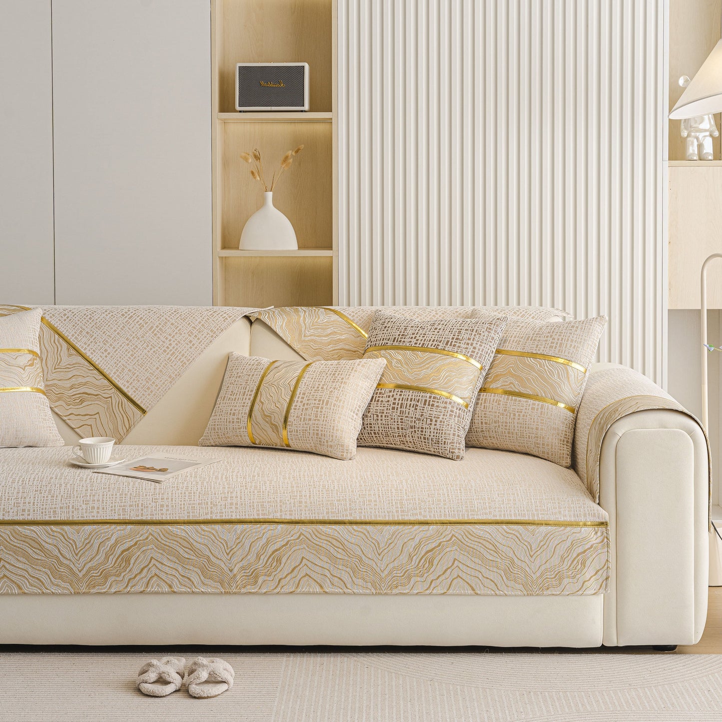 Modern Non-Slip Couch Slipcover, Soft, Durable & Washable Furniture Protector with gold marble-style trim on a light-colored sofa.
