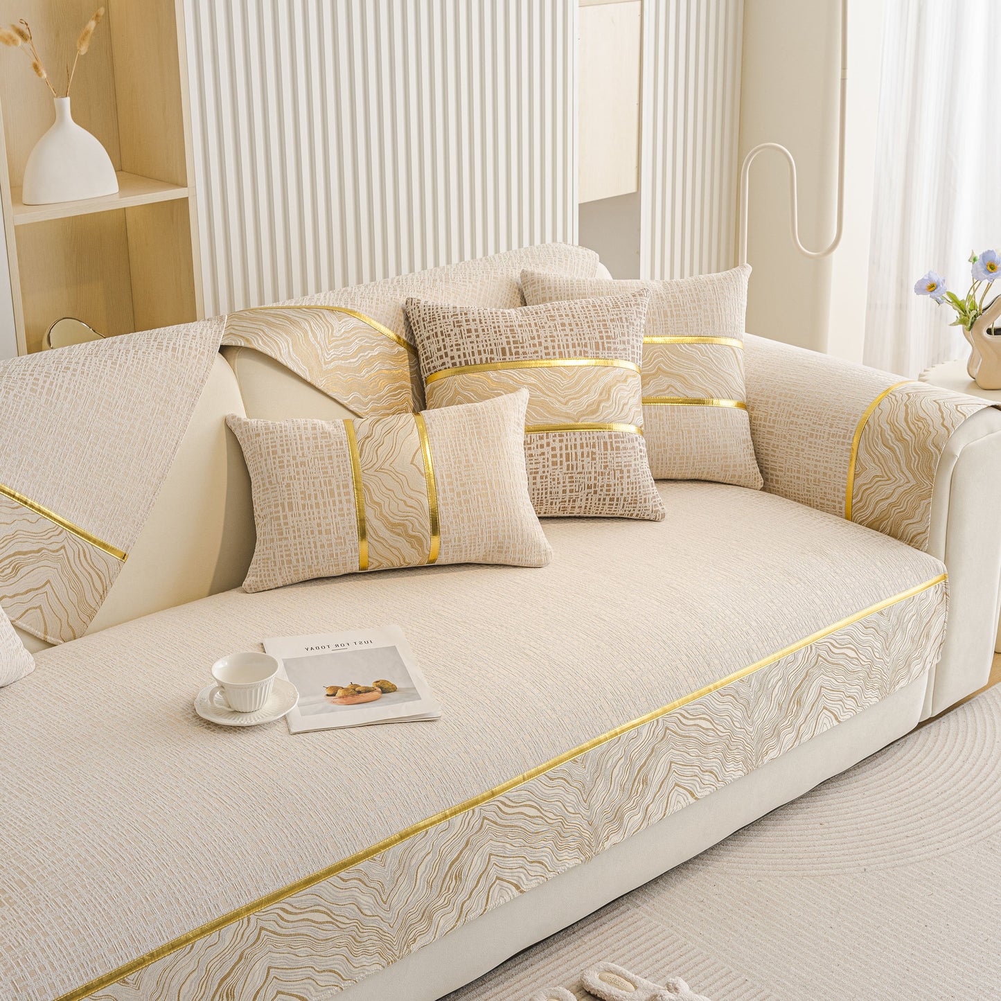 Modern Non-Slip Couch Slipcover, Soft, Durable & Washable Furniture Protector with gold marble-style trim on a chic sofa setting.