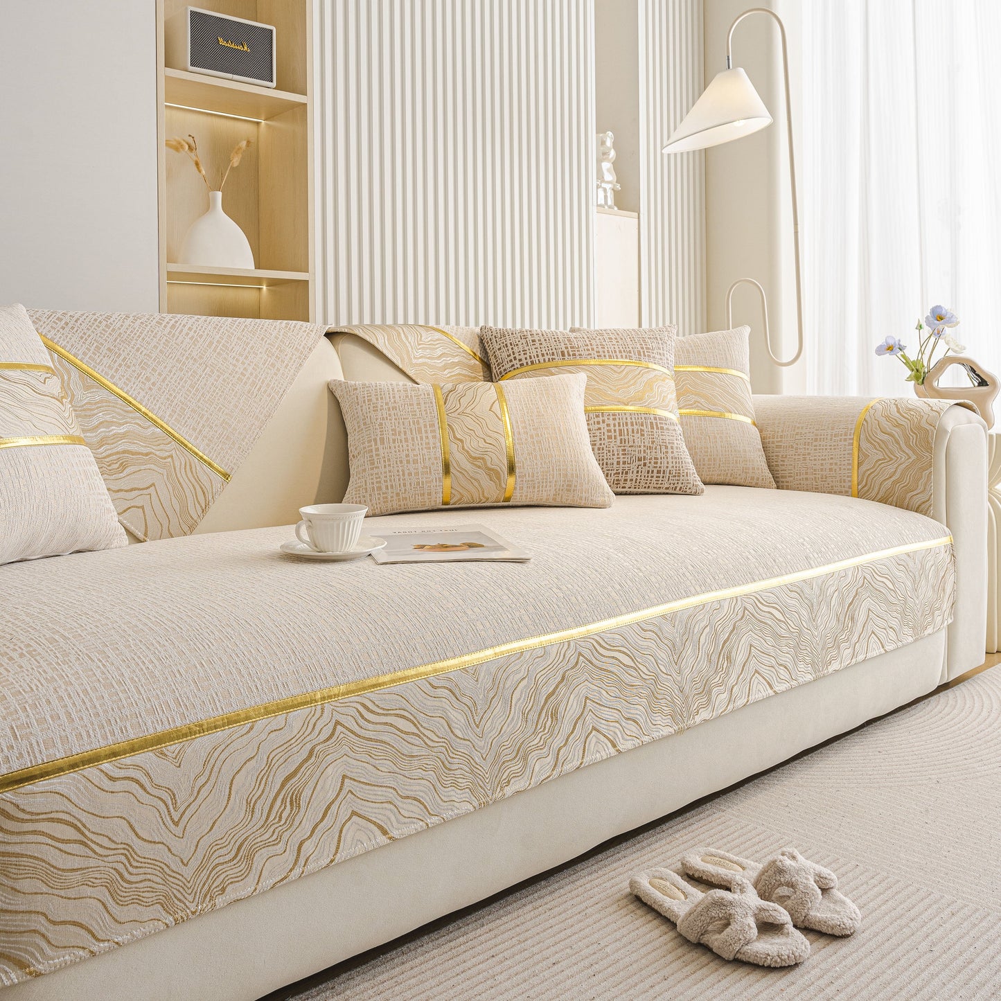 Modern Non-Slip Couch Slipcover, Soft, Durable & Washable Furniture Protector with gold marble trim on a beige sofa.