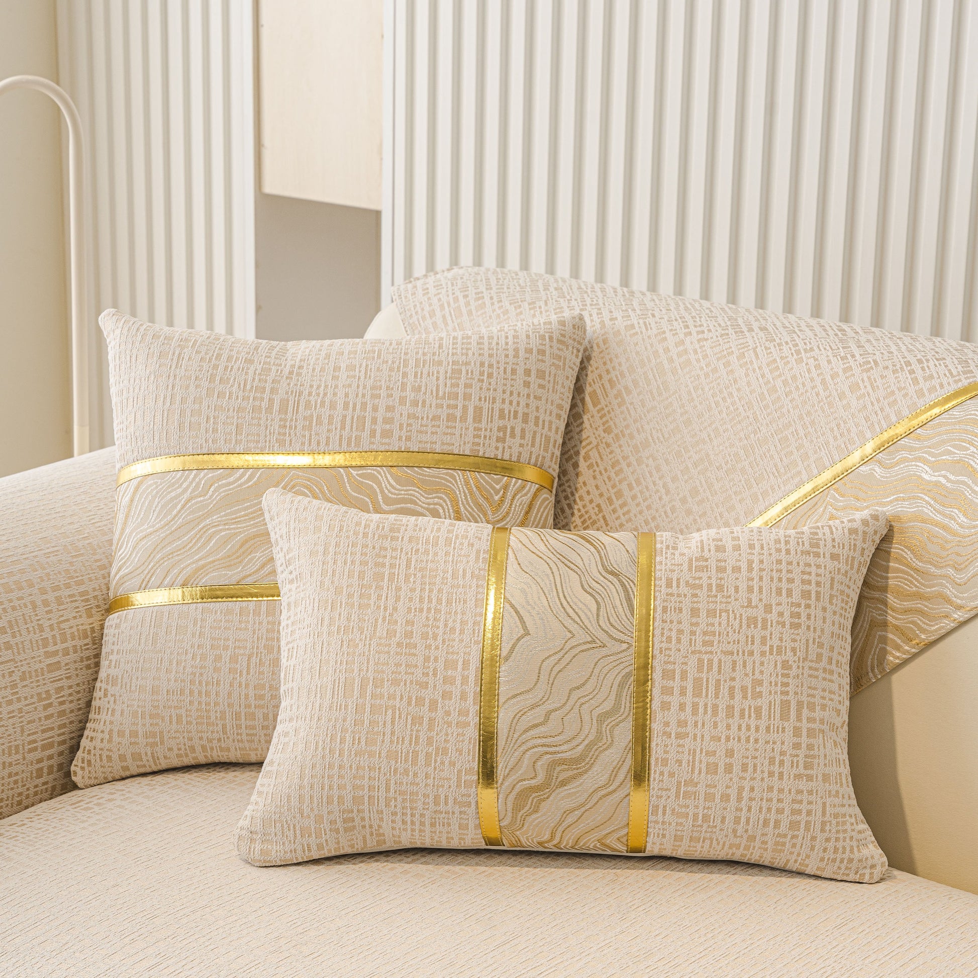 Modern Non-Slip Couch Slipcover, Soft, Durable & Washable Furniture Protector with gold marble-style trim on pillows.