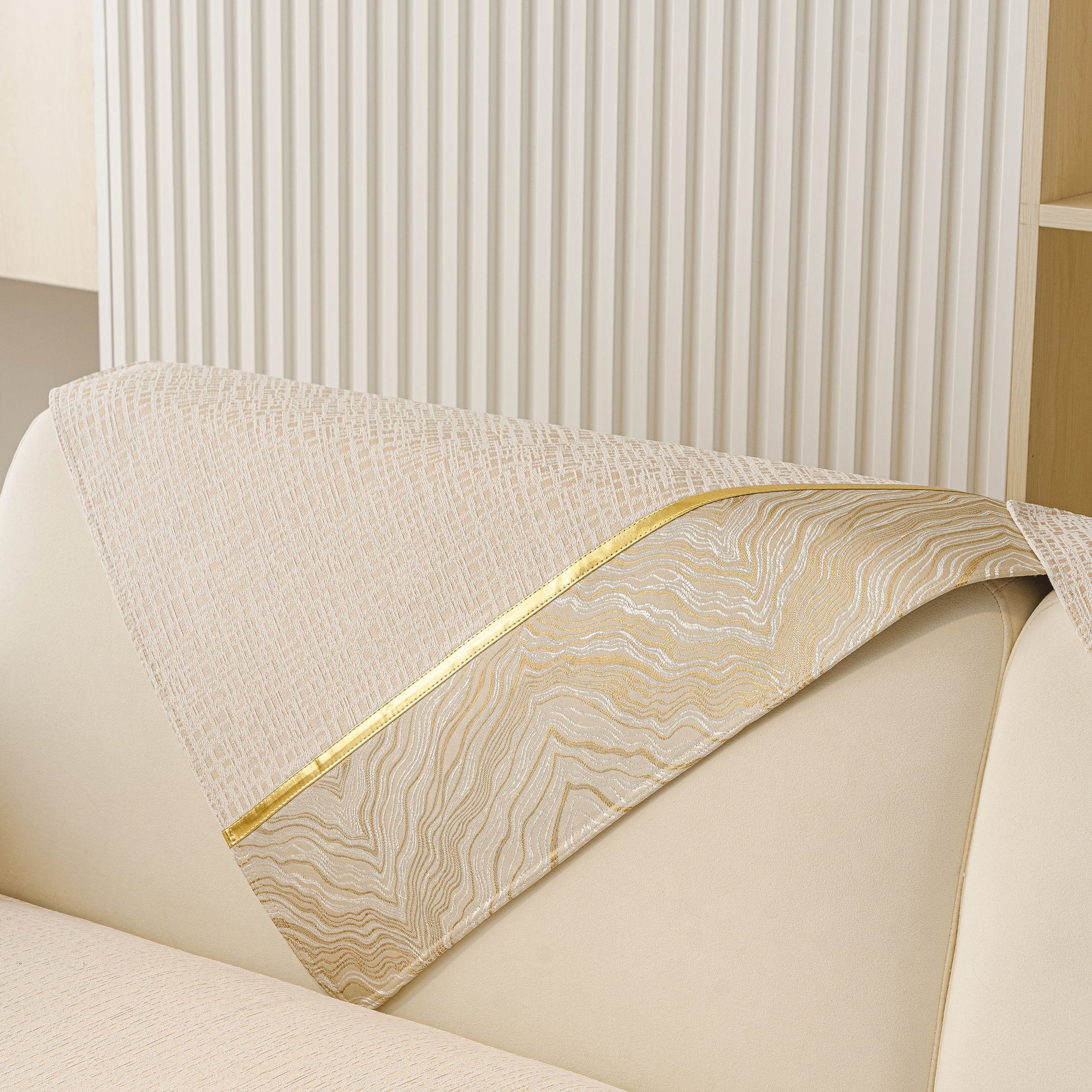 Modern Non-Slip Couch Slipcover, Soft, Durable & Washable Furniture Protector with gold marble-style trim on sofa arm.