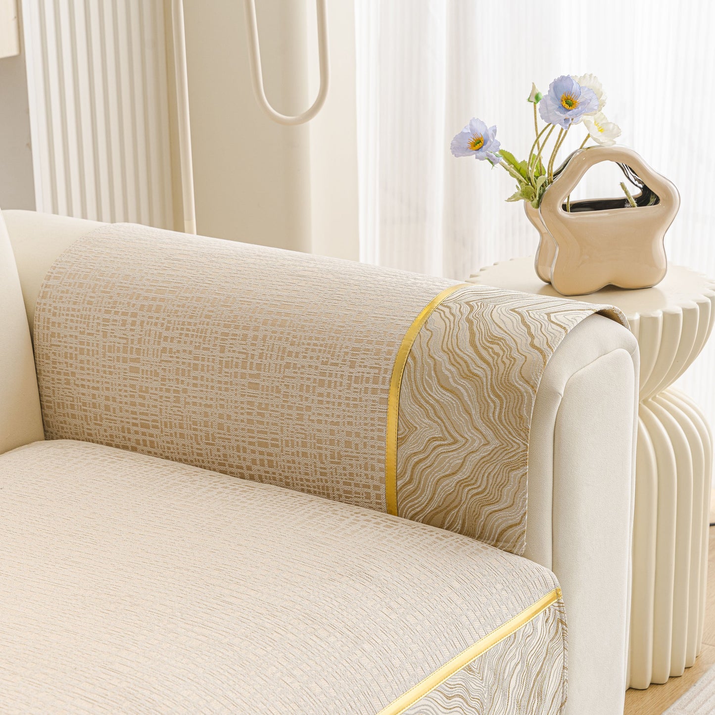 Modern Non-Slip Couch Slipcover, Soft, Durable & Washable Furniture Protector with gold marble-style trim on a beige sofa.