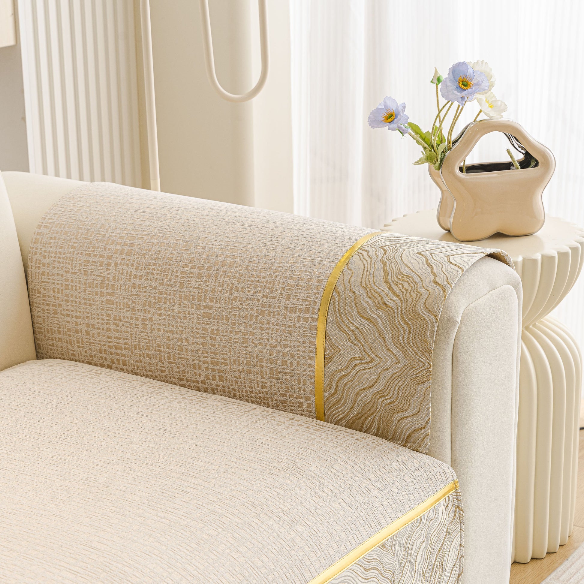 Modern Non-Slip Couch Slipcover, Soft, Durable & Washable Furniture Protector with gold marble-style trim on a beige sofa.