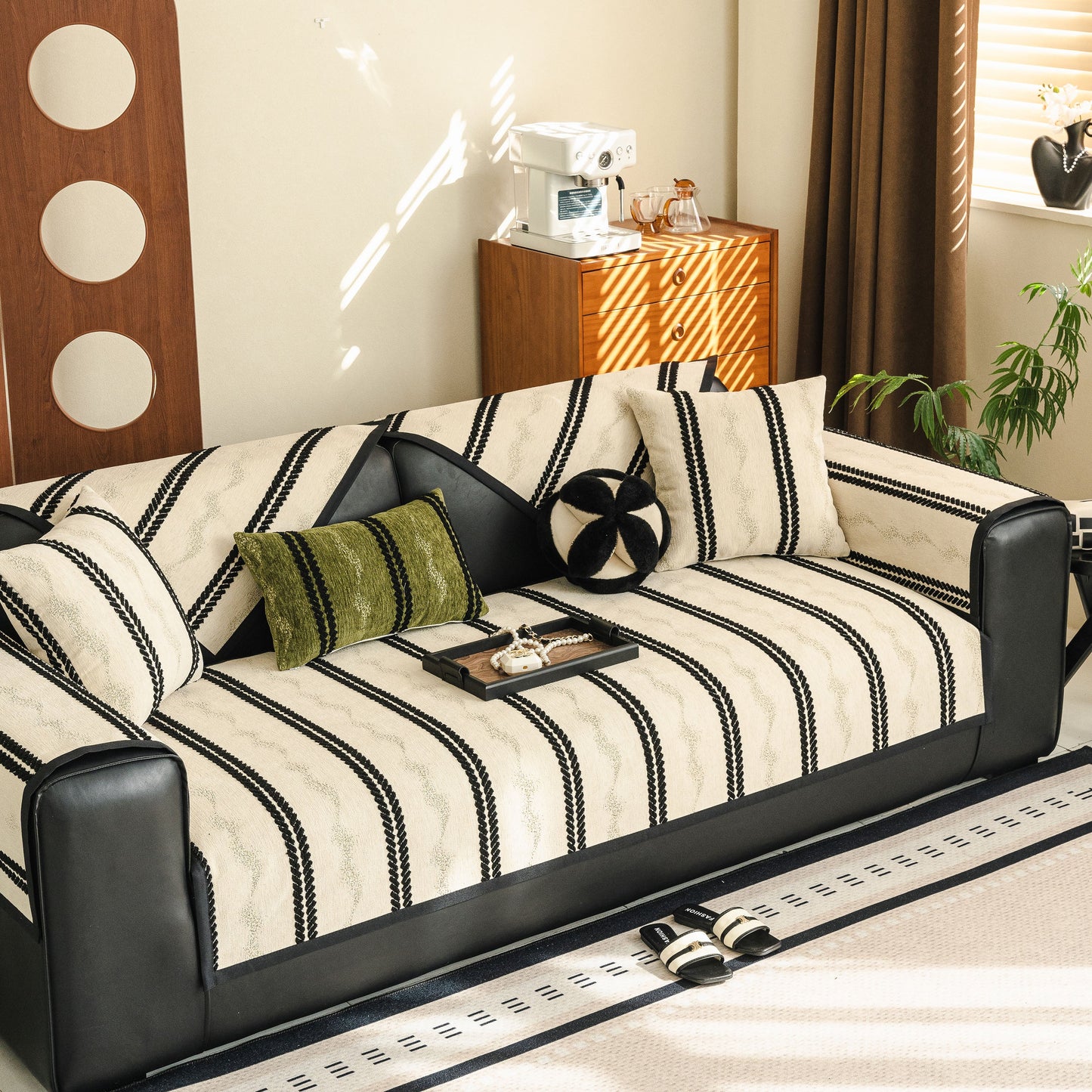 Living room with sofa featuring Non-Slip Sofa Cover with Thick Chenille Texture Woven Stripe Couch Protector Throw, decorative pillows.