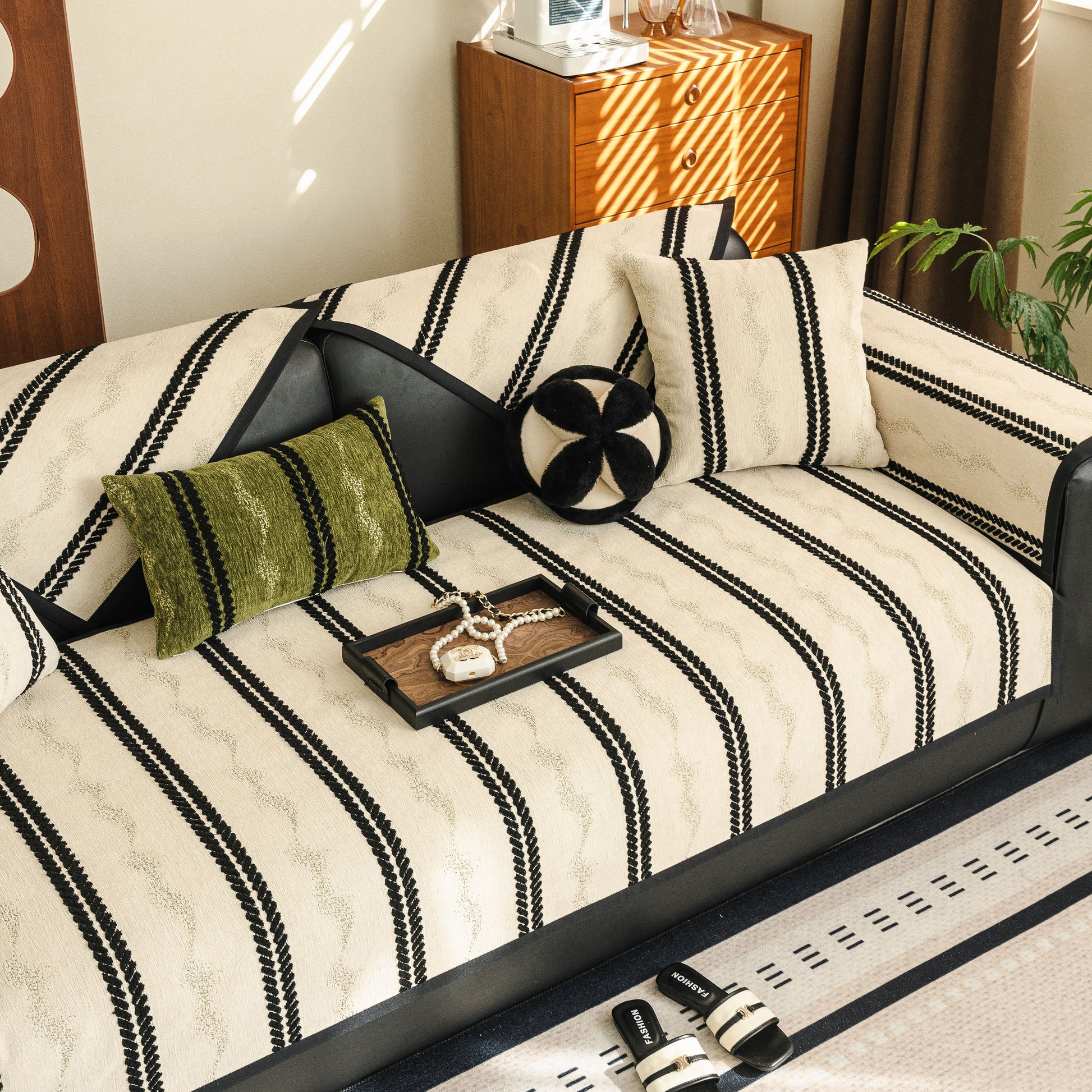Non-Slip Sofa Cover with Thick Chenille Texture Woven Stripe Couch Protector Throw on a modern sofa with decorative pillows.