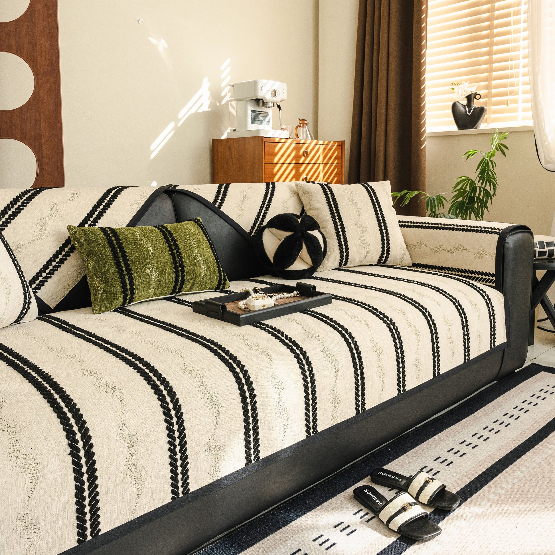 Cozy living room featuring a Non-Slip Sofa Cover with Thick Chenille Texture Woven Stripe Couch Protector Throw on a black leather sofa.