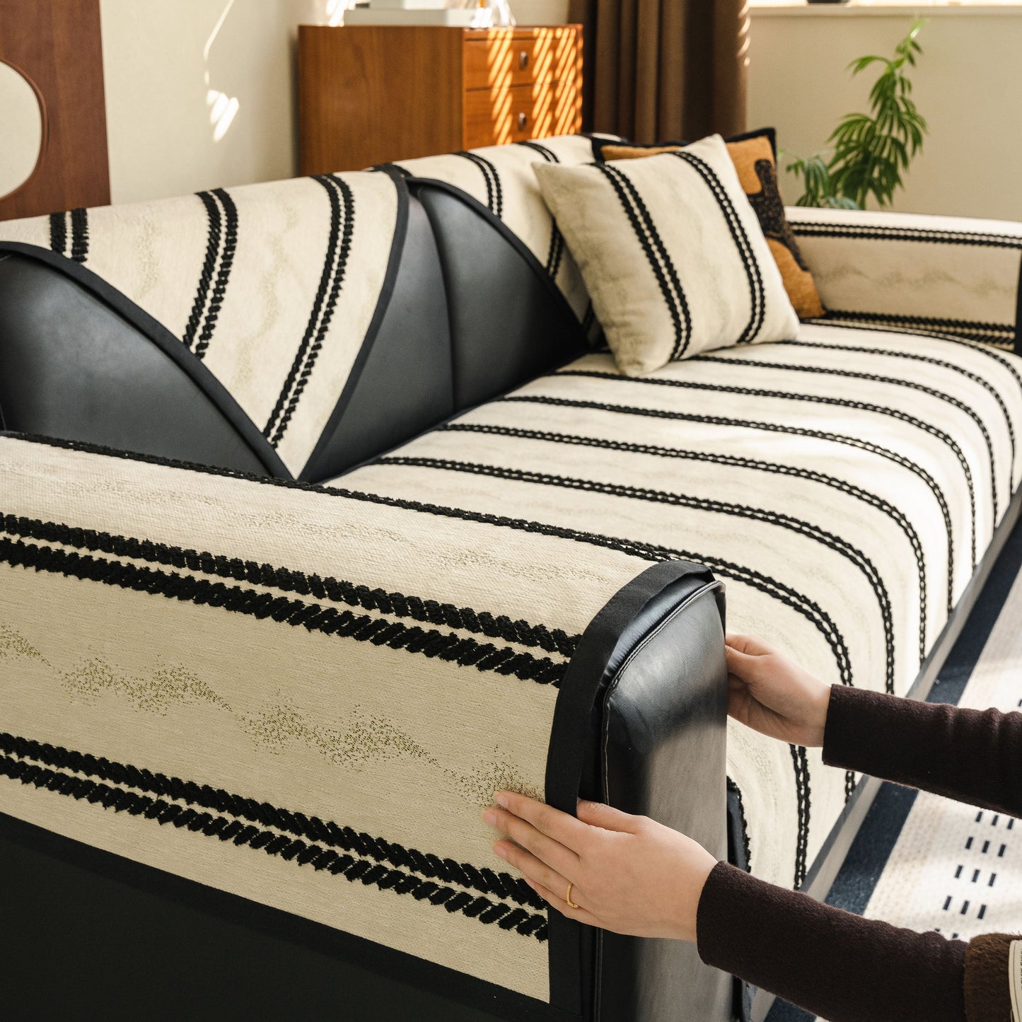 Non-Slip Sofa Cover with Thick Chenille Texture Woven Stripe Couch Protector Throw on black and white sofa.