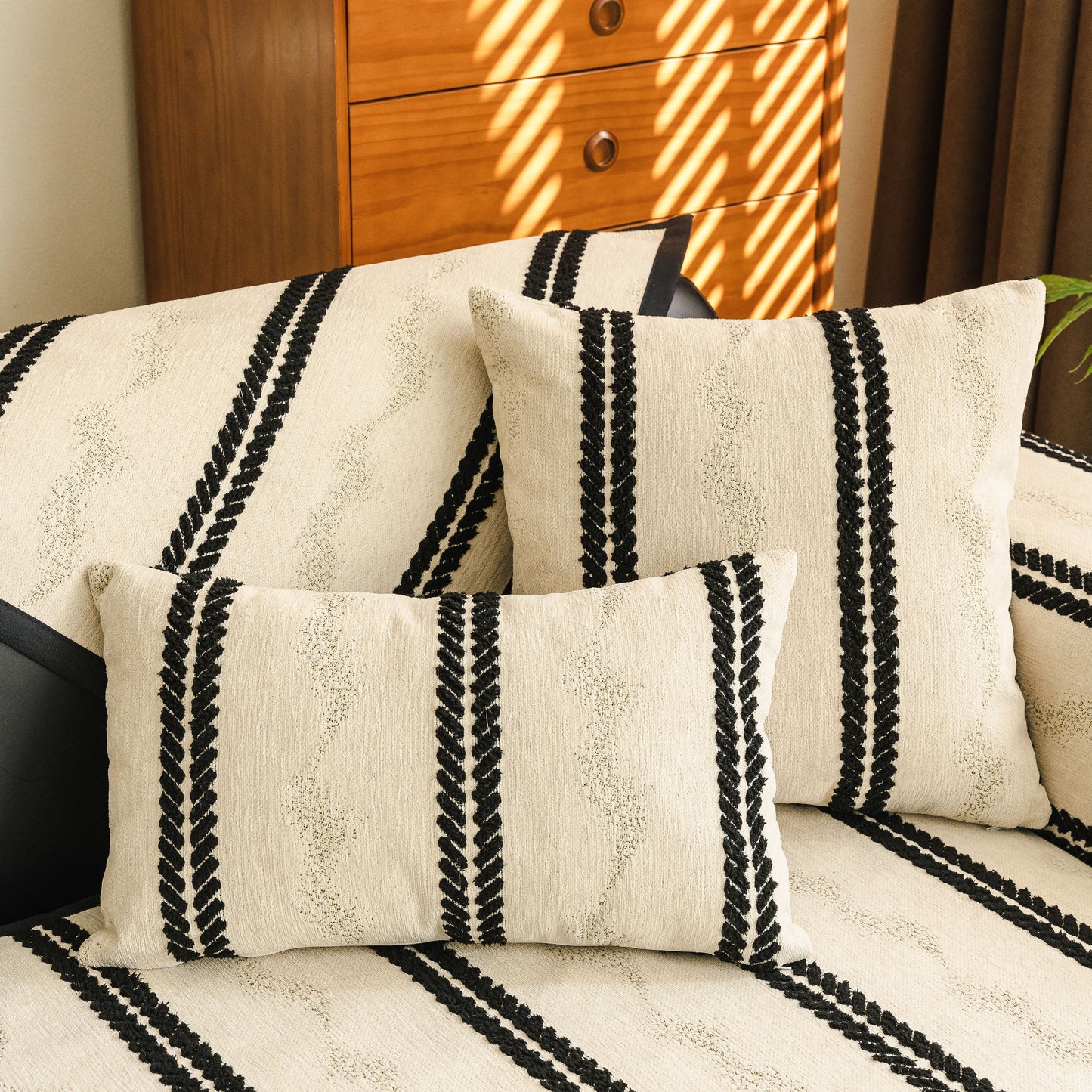 Non-Slip Sofa Cover with Thick Chenille Texture Woven Stripe Couch Protector Throw on a sofa with matching cushions.