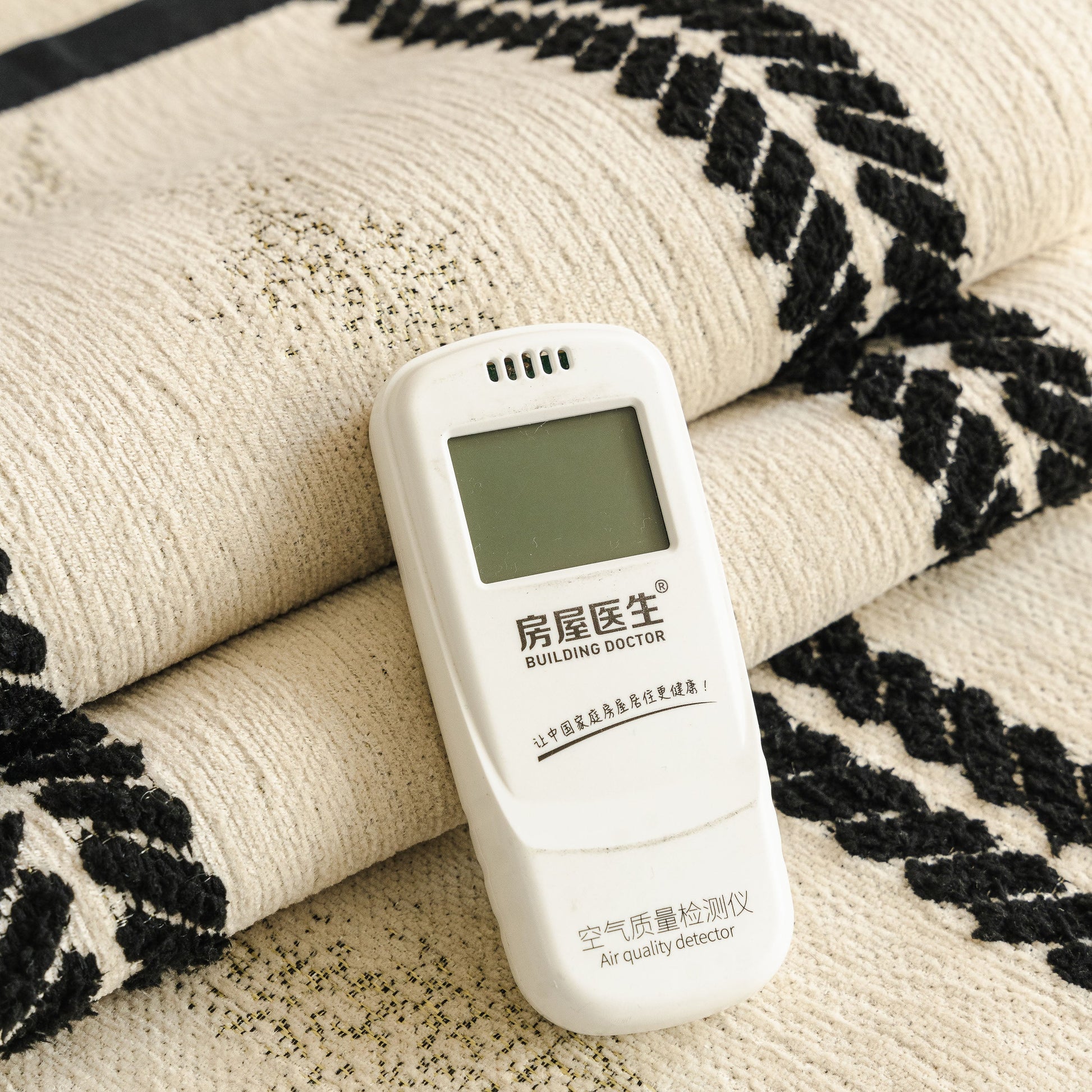 Non-Slip Sofa Cover with Thick Chenille Texture Woven Stripe Couch Protector Throw shown with air quality detector