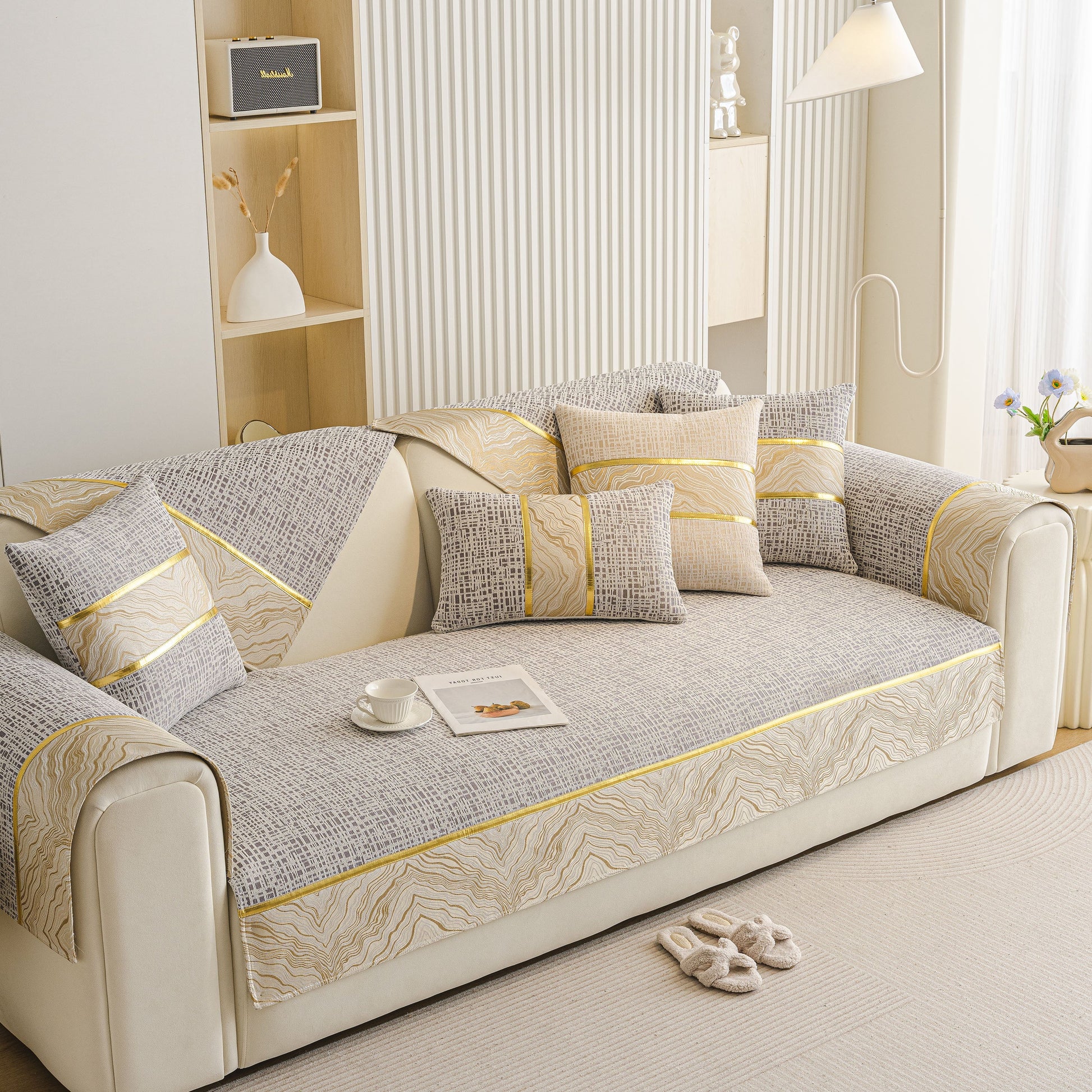 Modern Non-Slip Couch Slipcover, Soft, Durable & Washable Furniture Protector on beige sofa with gold marble-style trim design.