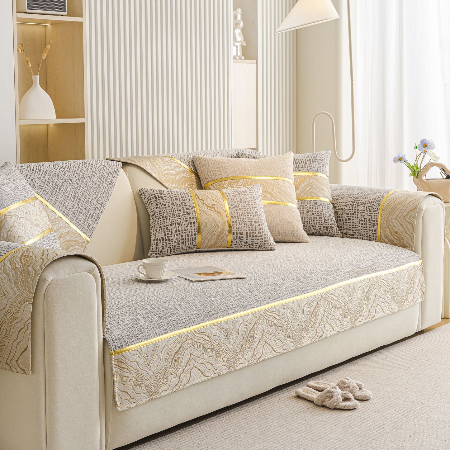 Modern Non-Slip Couch Slipcover, Soft, Durable & Washable Furniture Protector with gold marble trim on sofa in living room setting.