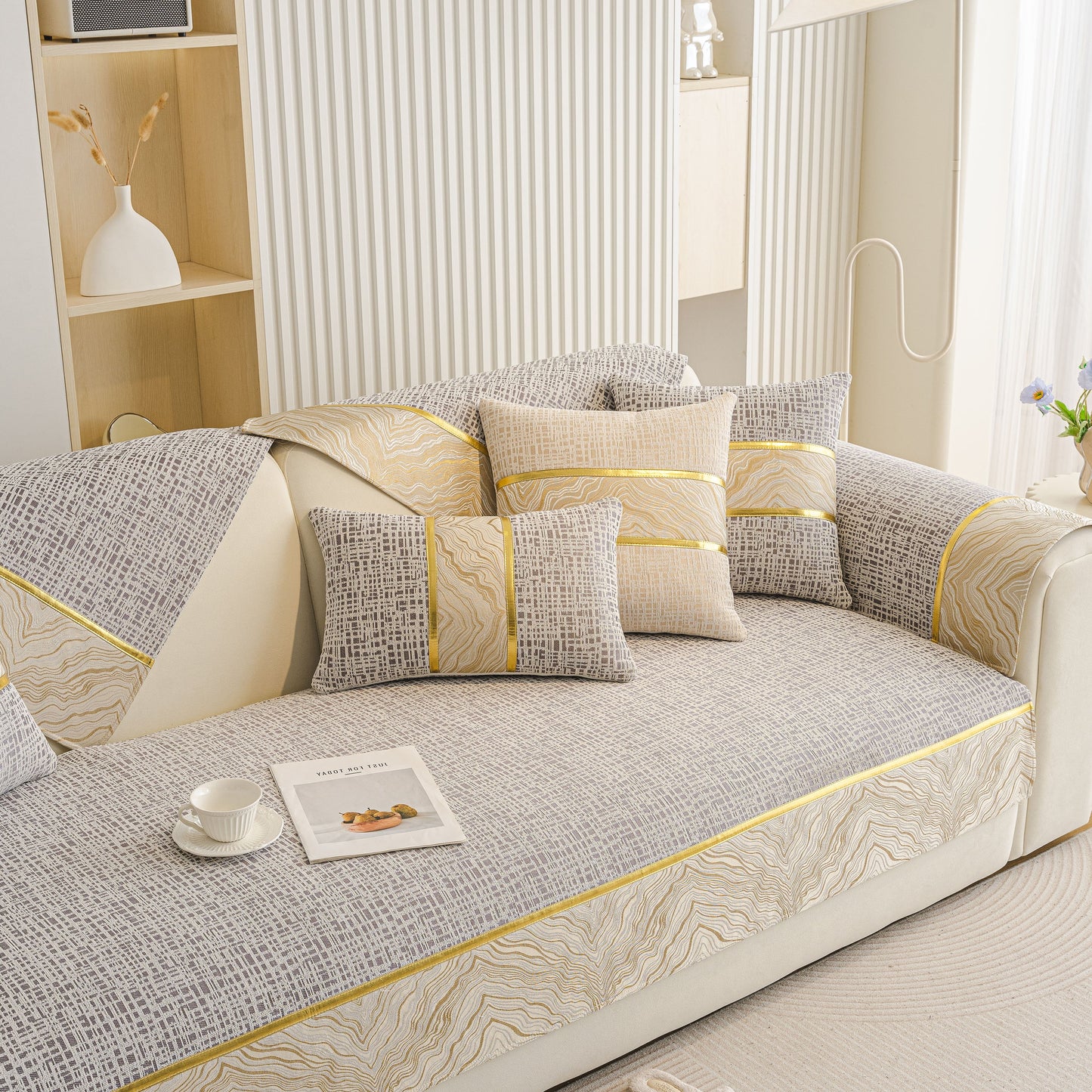 Modern Non-Slip Couch Slipcover, Soft, Durable & Washable Furniture Protector with gold marble-style trim on a sofa