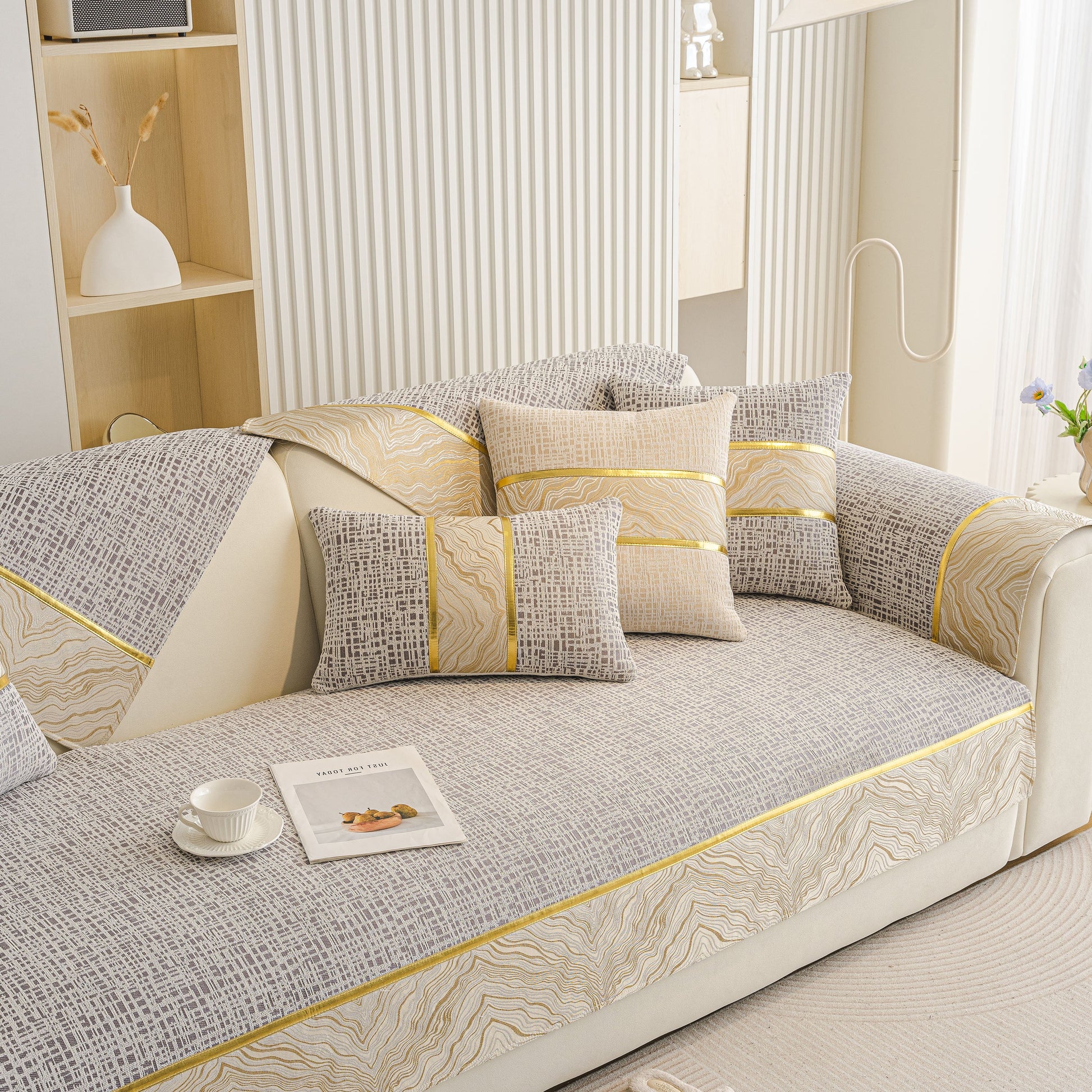 Modern Non-Slip Couch Slipcover, Soft, Durable & Washable Furniture Protector with gold marble-style trim on a sofa