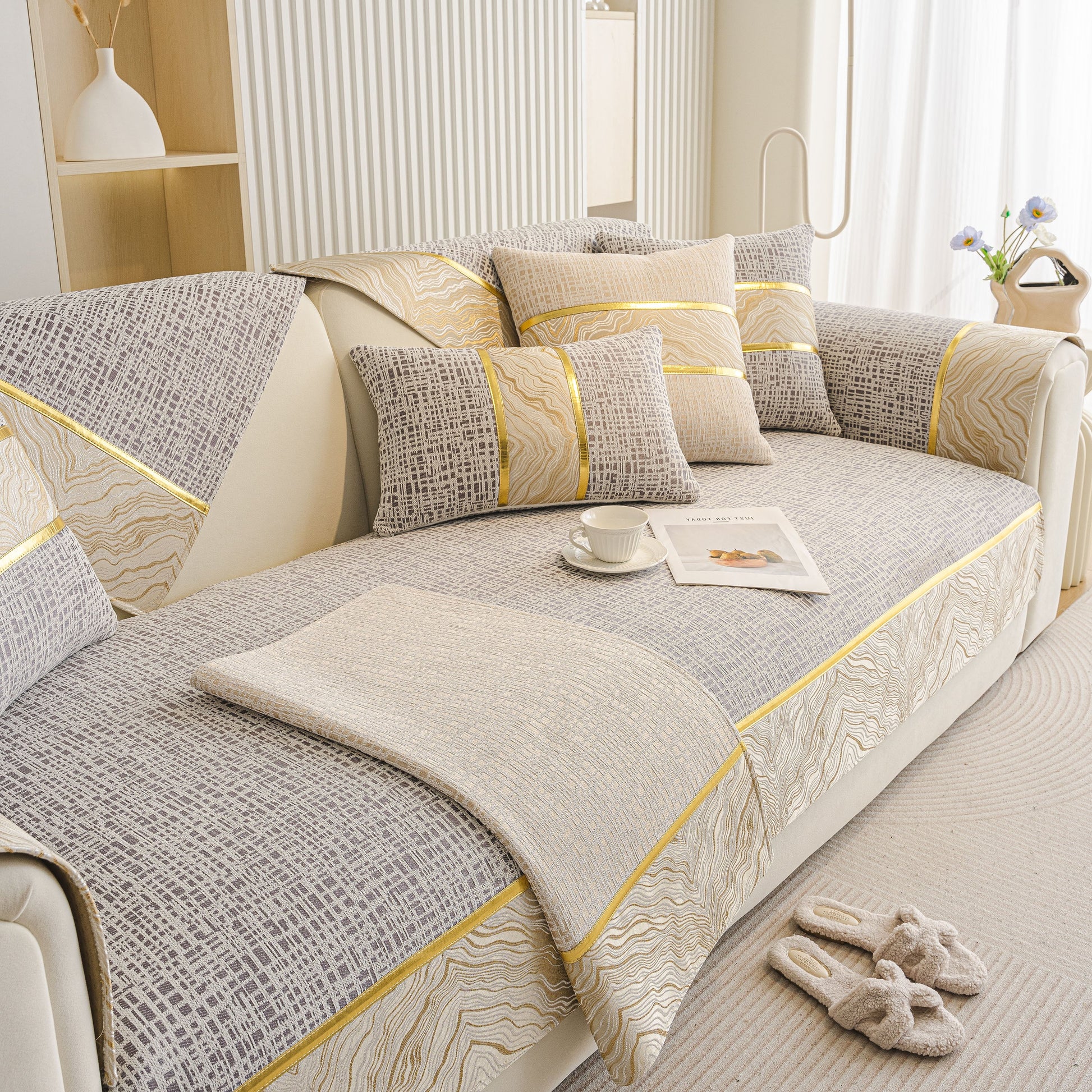 Modern Non-Slip Couch Slipcover, Soft, Durable & Washable Furniture Protector with gold marble-style trim on a beige sofa