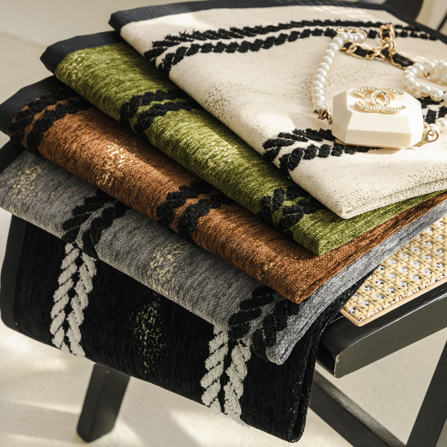 Non-Slip Sofa Cover with Thick Chenille Texture Woven Stripe Couch Protector Throw displayed in assorted colors on chair.