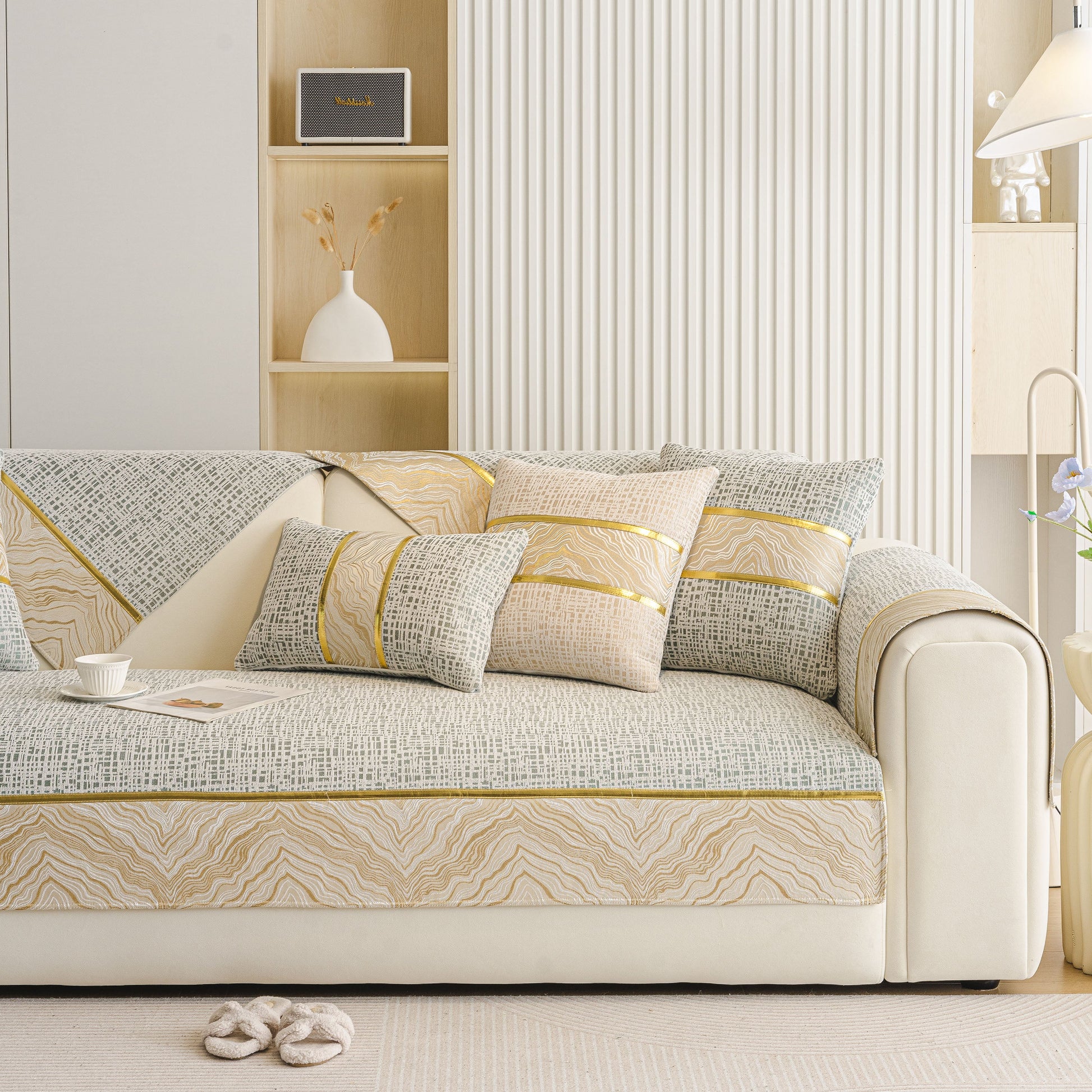 Modern Non-Slip Couch Slipcover, Soft, Durable & Washable Furniture Protector with gold marble-style trim on sofa.