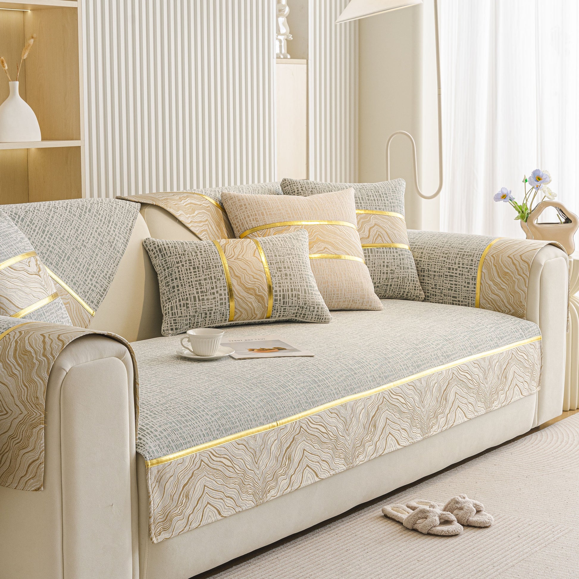 Modern Non-Slip Couch Slipcover, Soft, Durable & Washable Furniture Protector with gold marble-style trim on a beige sofa.