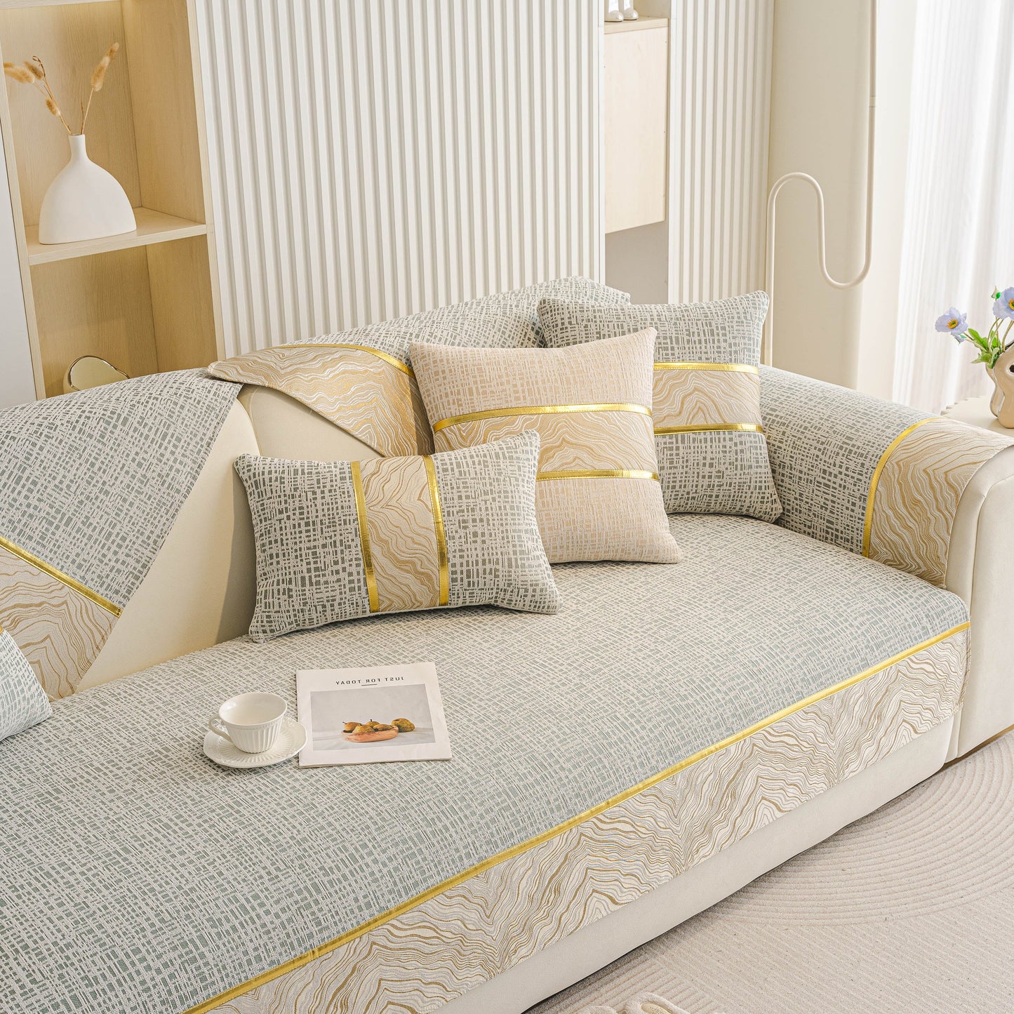 Modern Non-Slip Couch Slipcover, Soft, Durable & Washable Furniture Protector with gold marble-style trim on a sofa