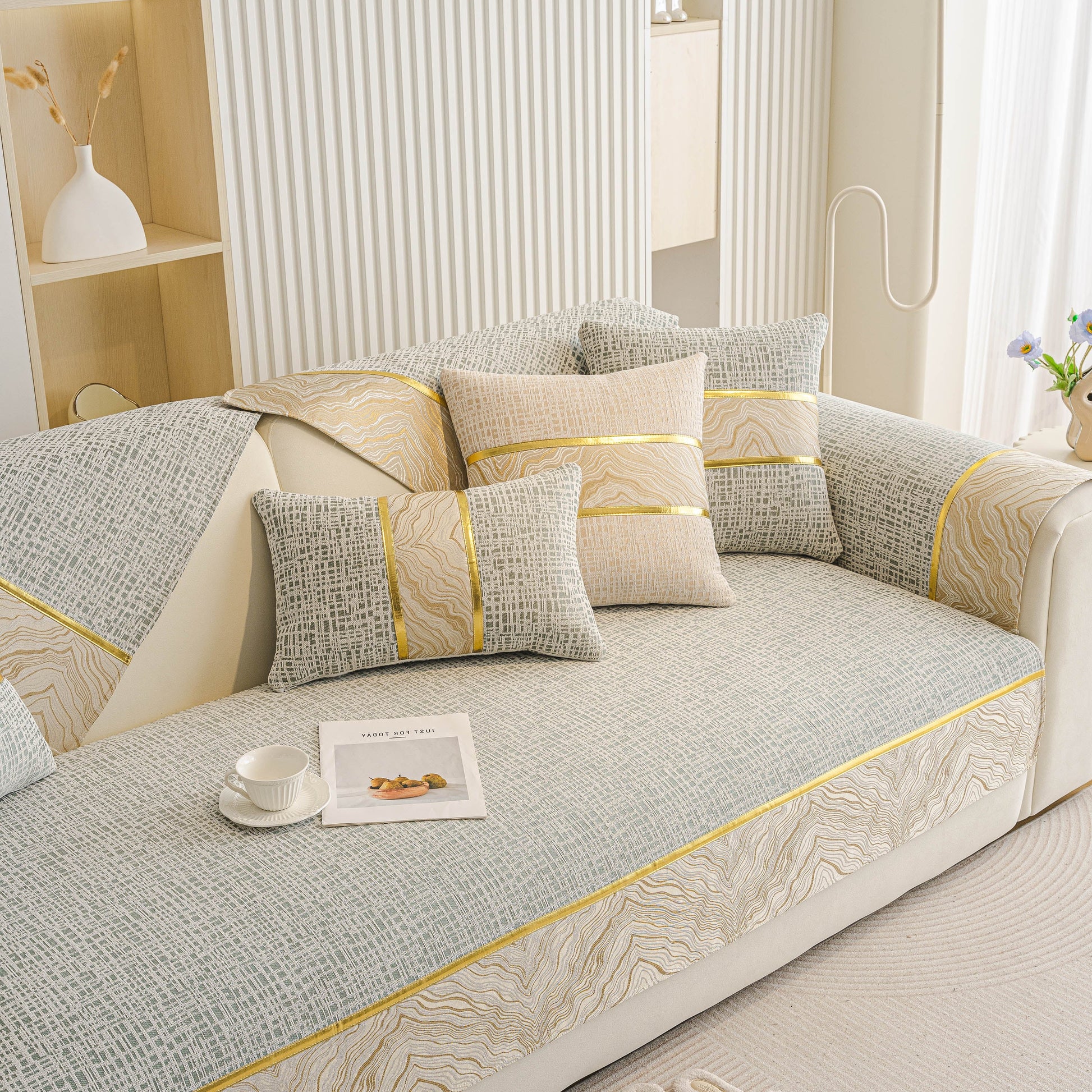 Modern Non-Slip Couch Slipcover, Soft, Durable & Washable Furniture Protector with gold marble-style trim on a sofa
