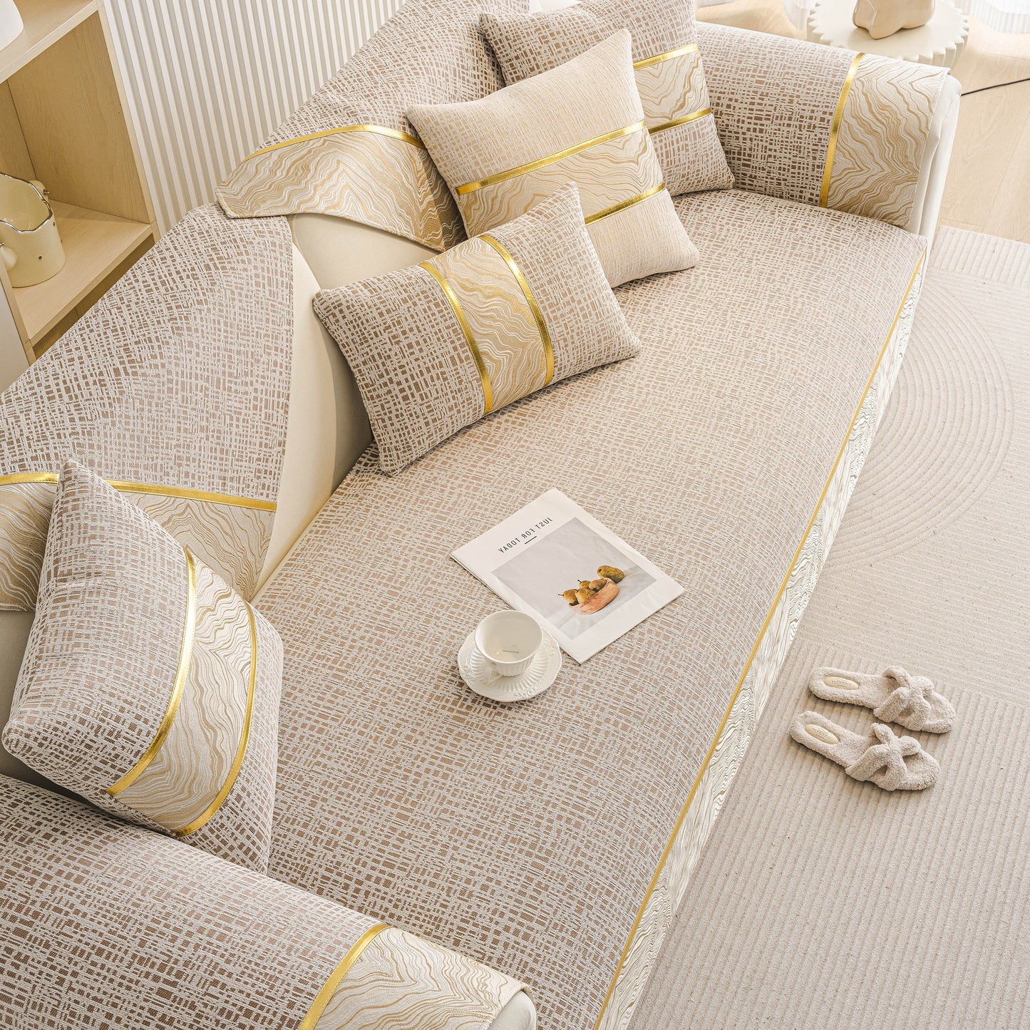 Modern Non-Slip Couch Slipcover, Soft, Durable & Washable Furniture Protector with gold marble-style trim on a sofa.