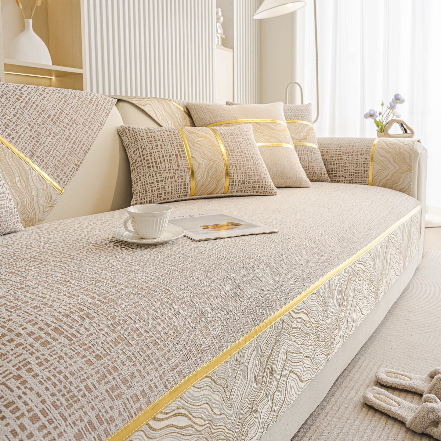 Modern Non-Slip Couch Slipcover, Soft, Durable & Washable Furniture Protector with gold marble-style trim on a sofa.