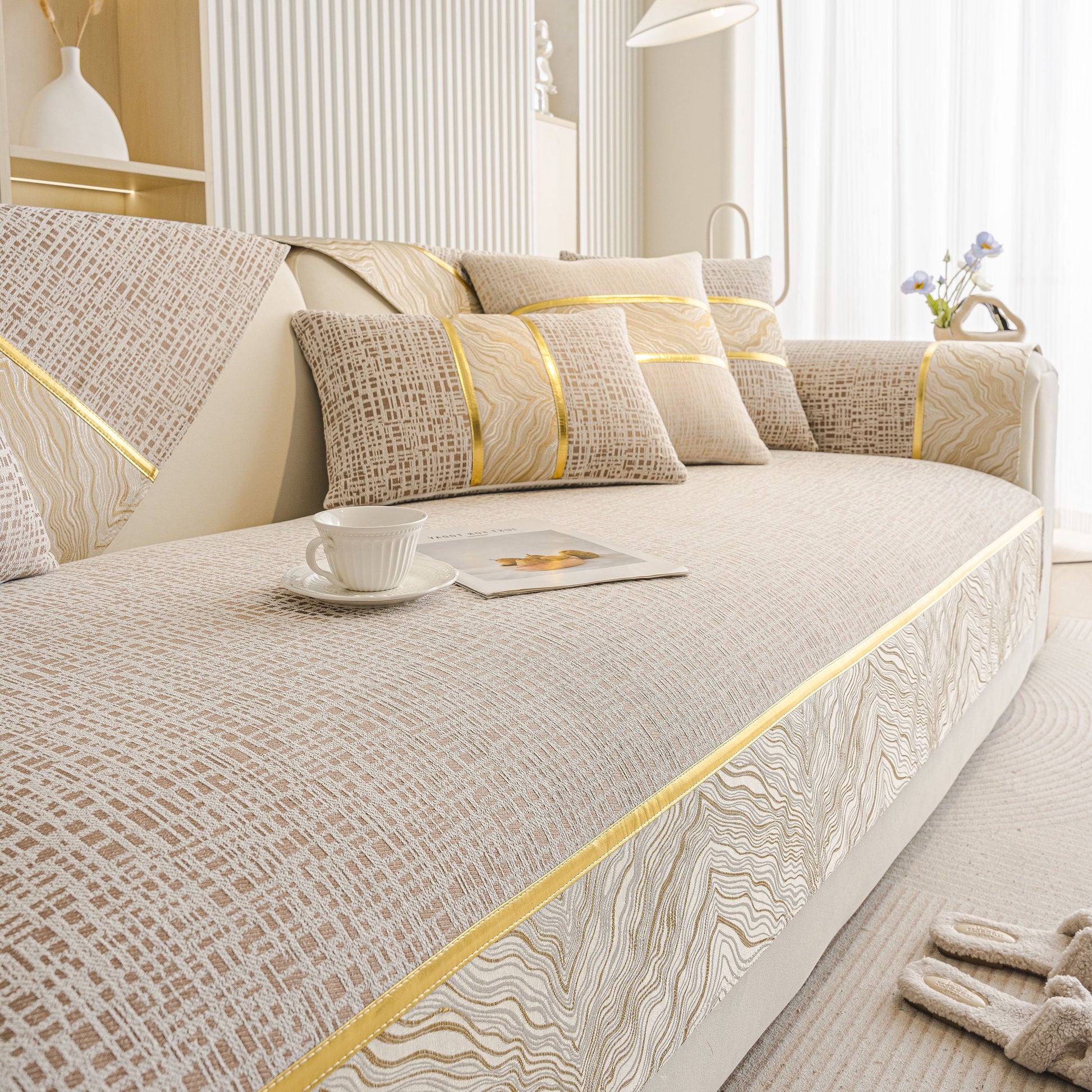 Modern Non-Slip Couch Slipcover, Soft, Durable & Washable Furniture Protector with gold marble-style trim on a sofa.