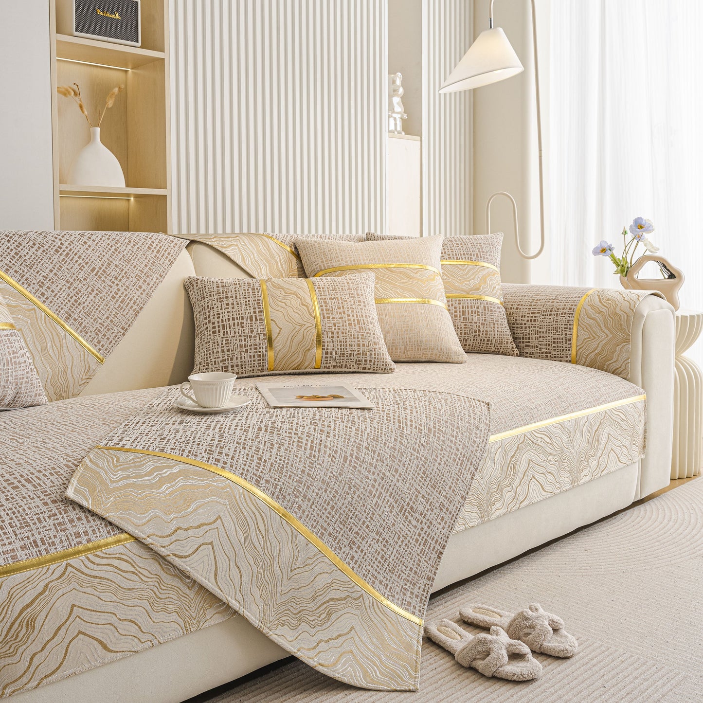 Modern Non-Slip Couch Slipcover, Soft, Durable & Washable Furniture Protector with gold marble-style trim on a beige sofa.