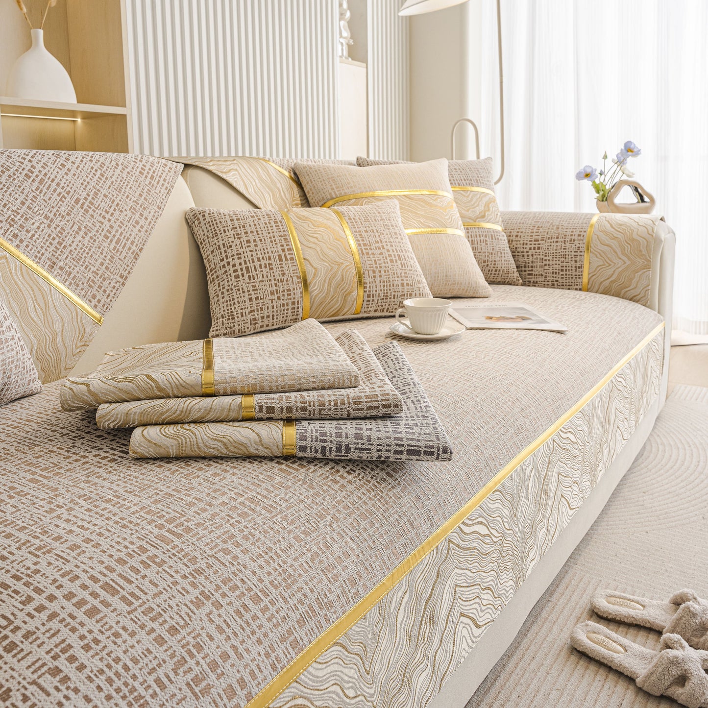 Modern Non-Slip Couch Slipcover, Soft, Durable & Washable Furniture Protector with gold marble-style trim on sofa.