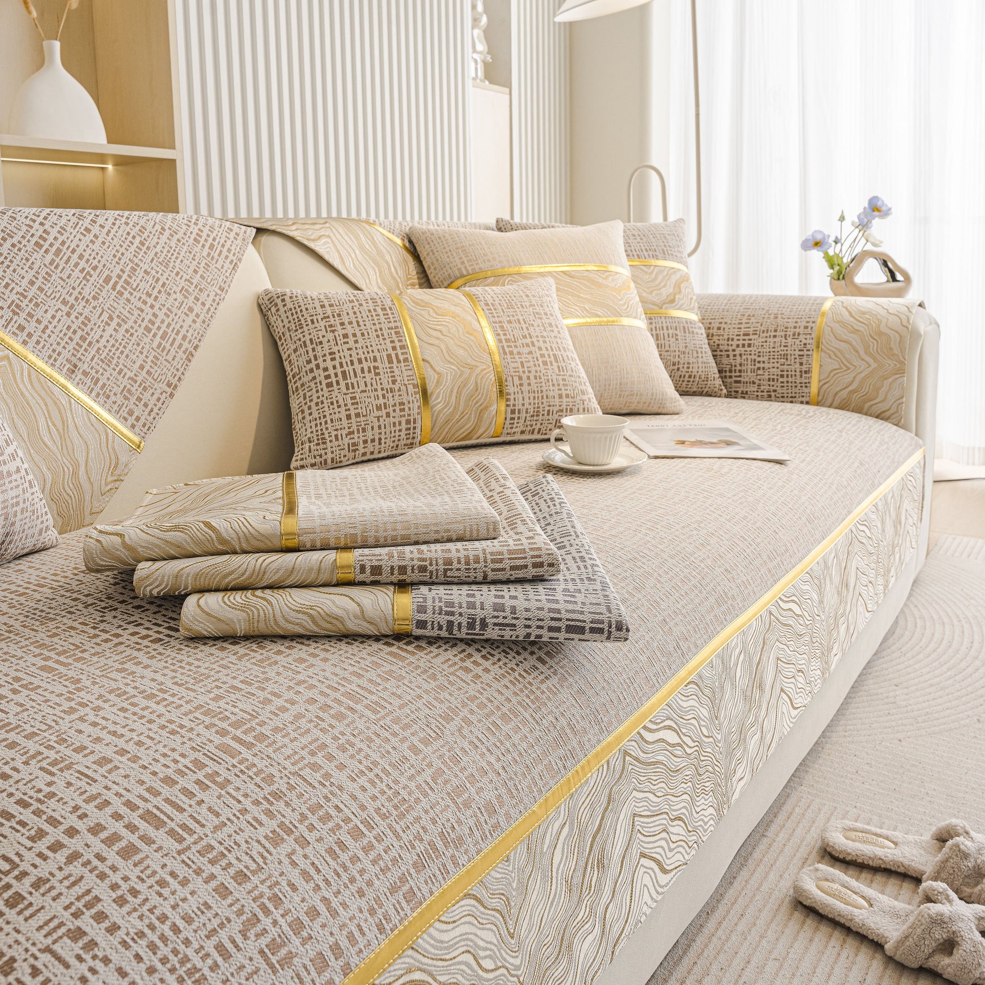 Modern Non-Slip Couch Slipcover, Soft, Durable & Washable Furniture Protector with gold marble-style trim on sofa.