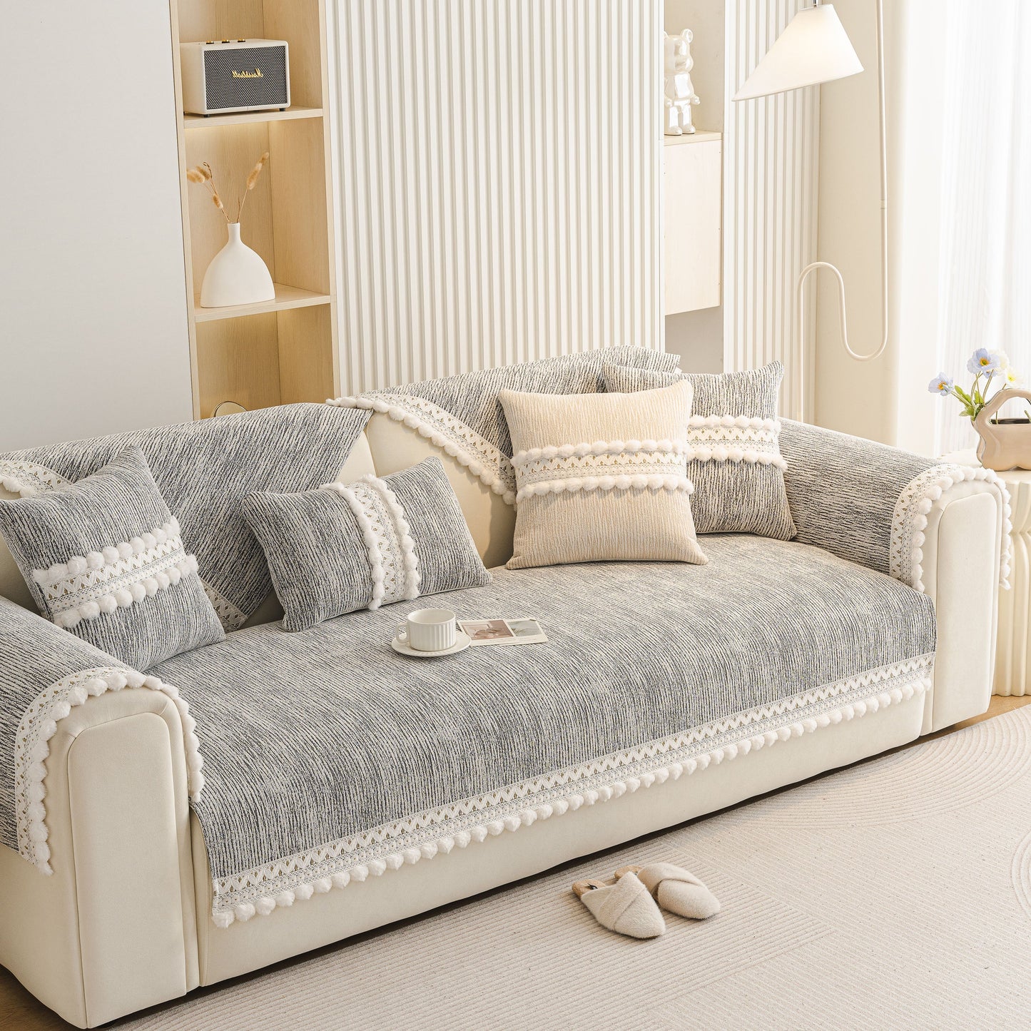 Soft Chenille Sectional Sofa Cover with Pom Pom Trim – Non-Slip Couch Protector on a modern beige sofa with decorative pillows.