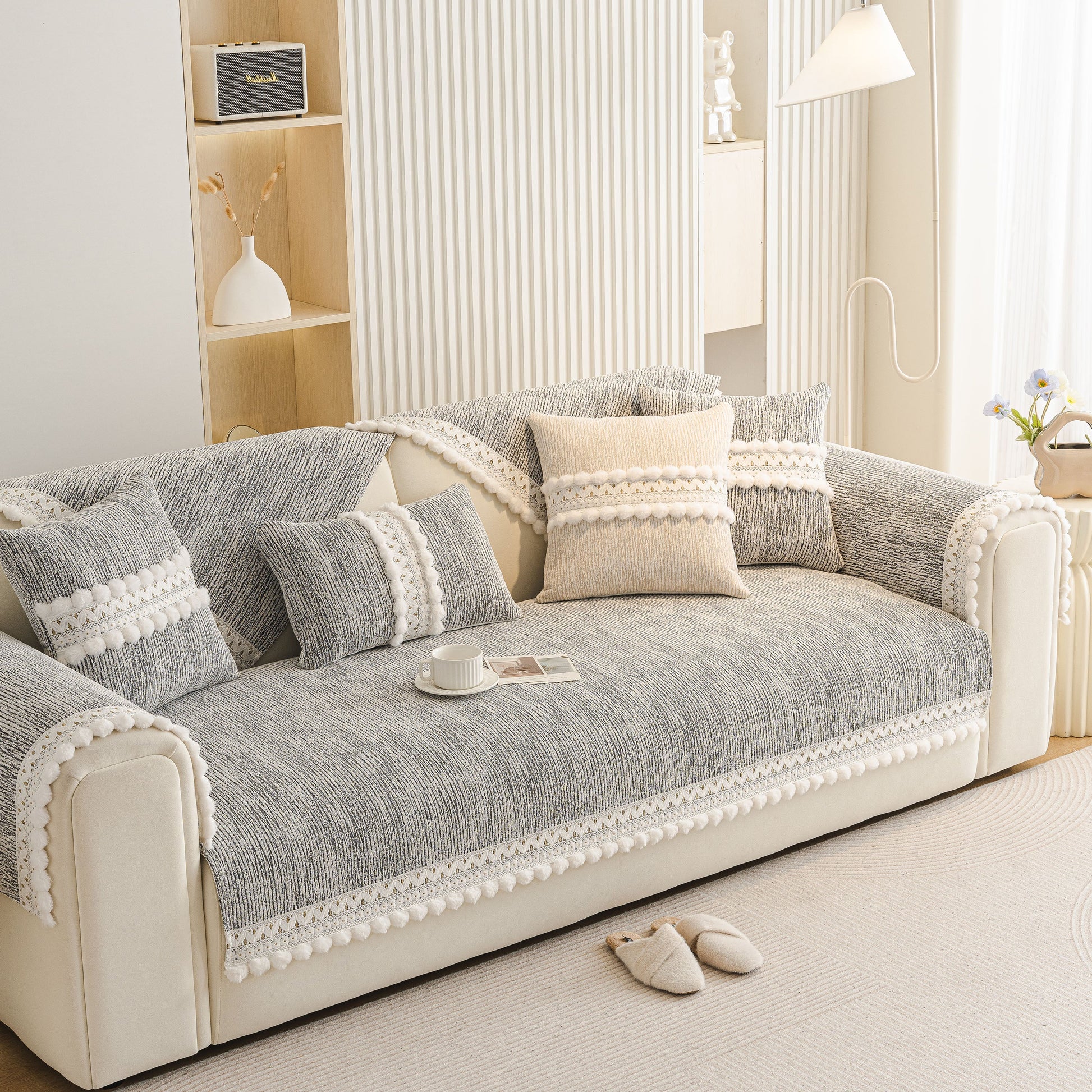 Soft Chenille Sectional Sofa Cover with Pom Pom Trim – Non-Slip Couch Protector on a modern beige sofa with decorative pillows.